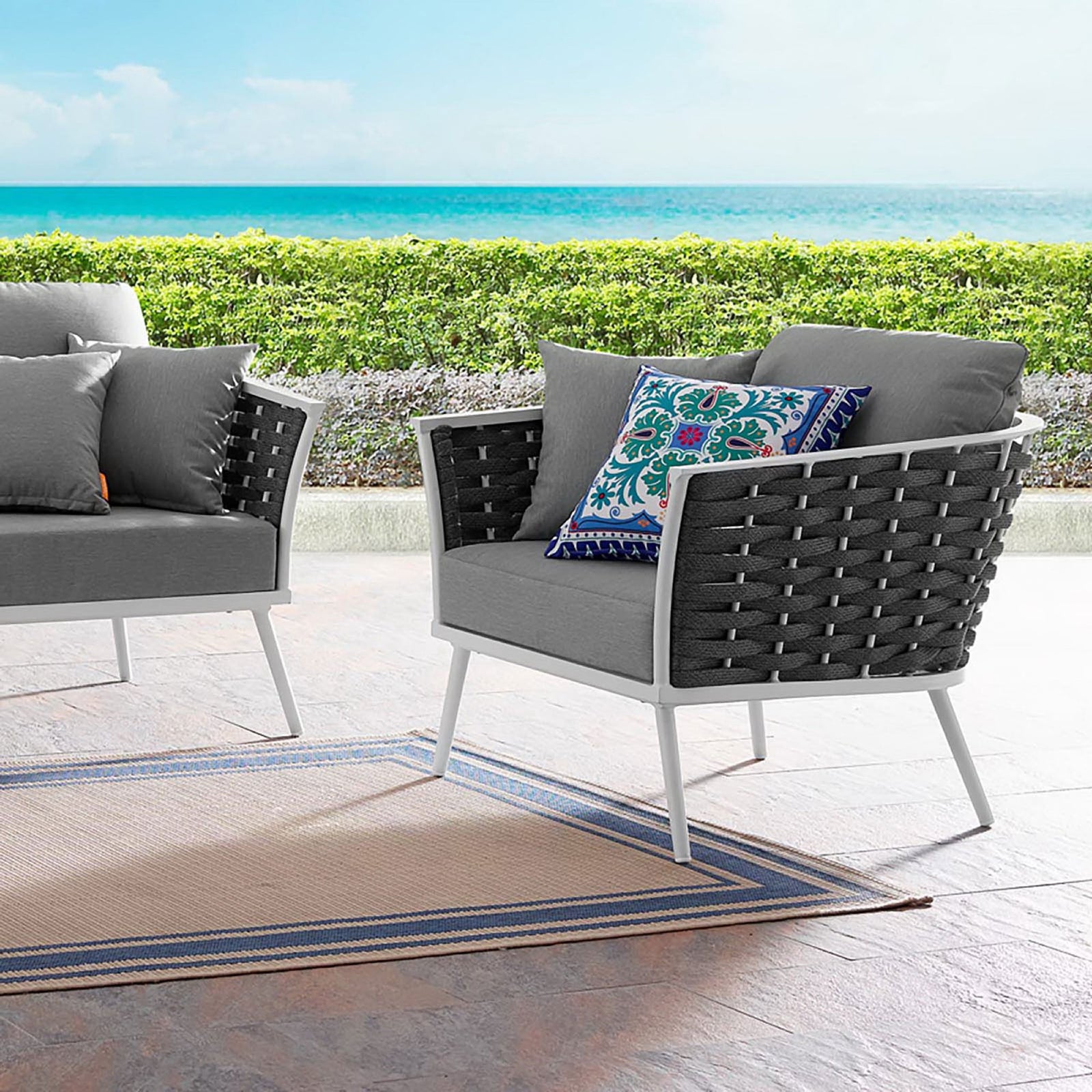 Stance outdoor armchair with gray cushions and rope sides styled on a coastal patio || EEI-3054-WHI-GRY || front_angle_room