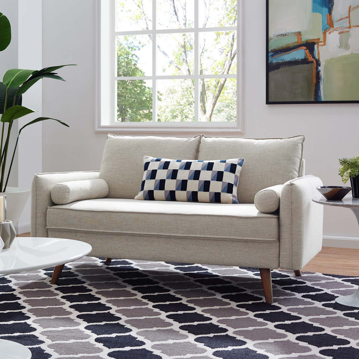 Light beige upholstery and tapered wood legs add an airy, welcoming feel to a modern living space.