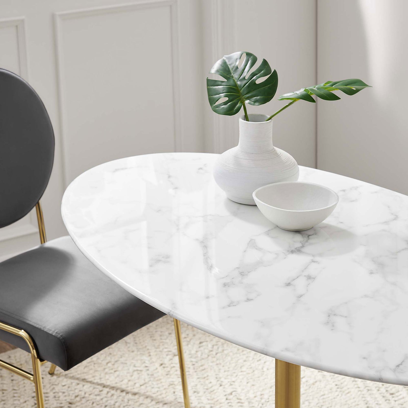 Faux marble tabletop decorated with vase, bowl, and greenery for a light modern dining setting || EEI-3216-GLD-WHI || detail_room