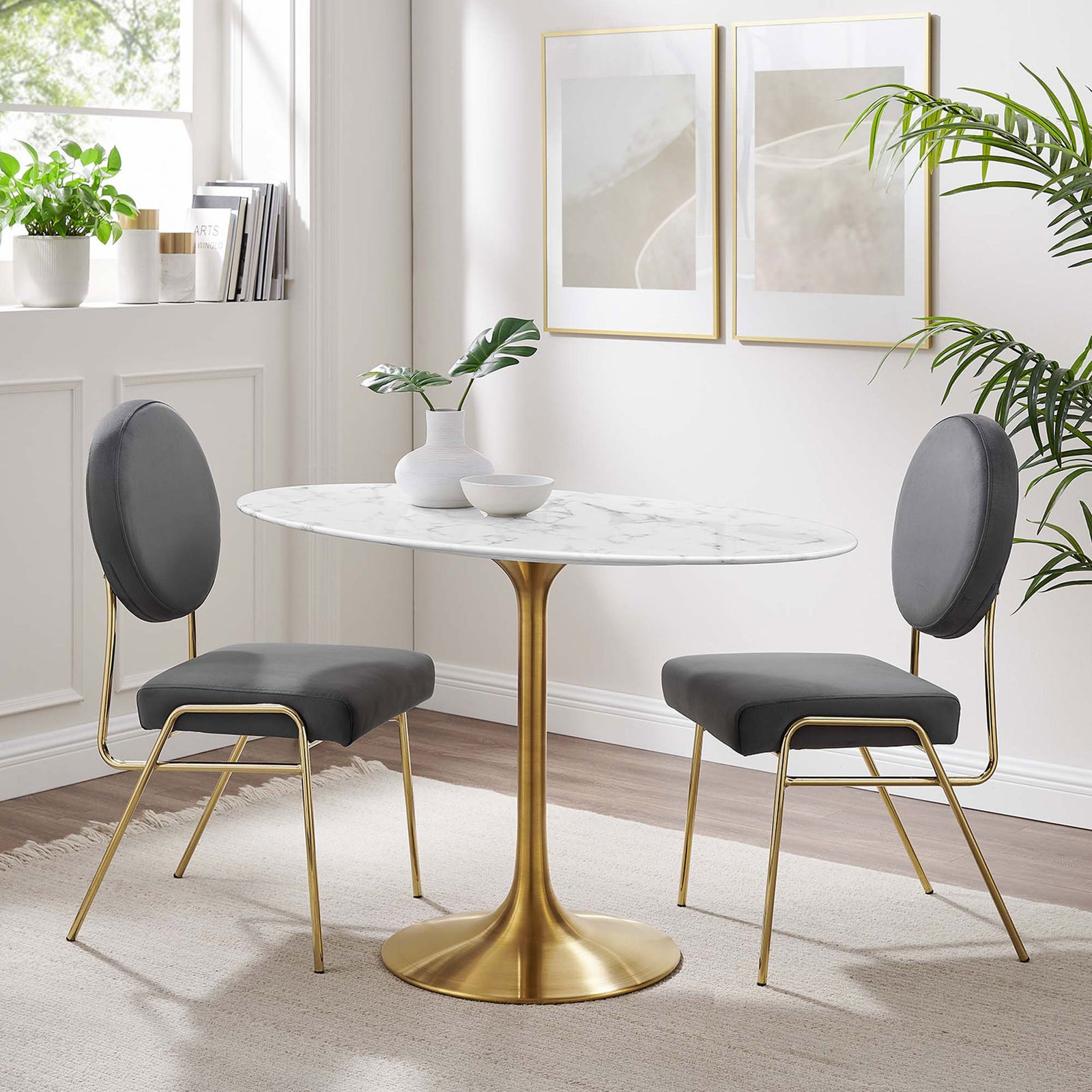 White faux marble dining table with gold pedestal base paired with gray chairs in a bright dining space || EEI-3216-GLD-WHI || front_angle_room