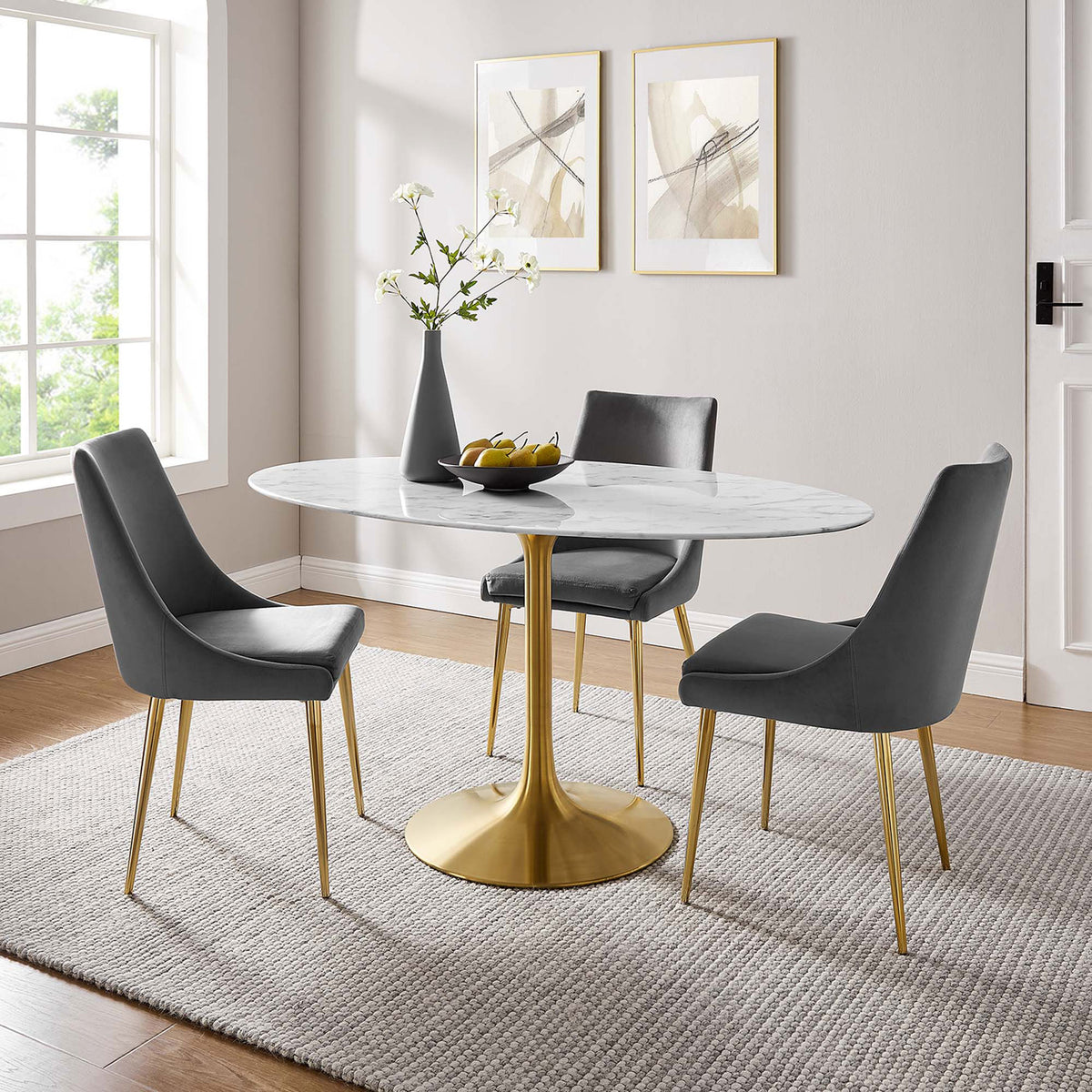 White faux marble dining table with gold pedestal base arranged with gray chairs in a warm dining room || EEI-3236-GLD-WHI || front_angle_room