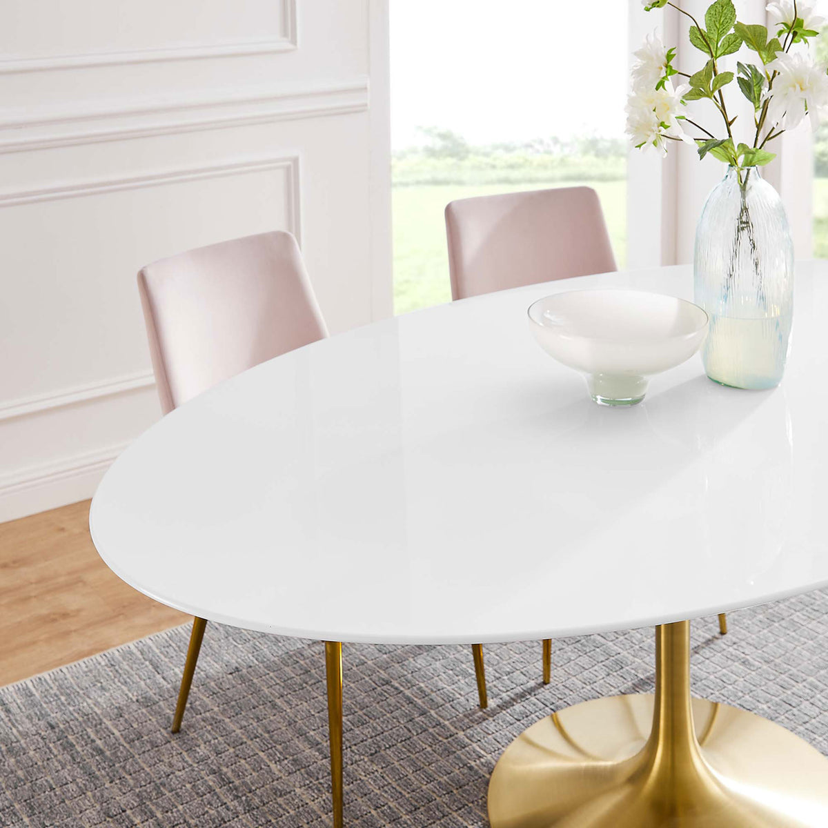 Glossy white tabletop with gold pedestal accented by a tall vase and bowl in a bright open space. || EEI-3255-GLD-WHI || detail_room