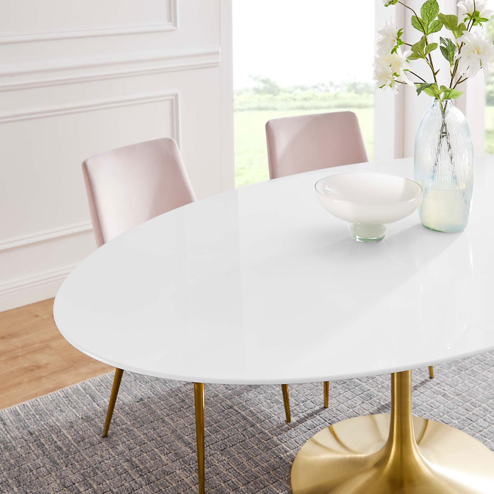 Glossy white tabletop with gold pedestal accented by a tall vase and bowl in a bright open space. || EEI-3255-GLD-WHI || detail_room