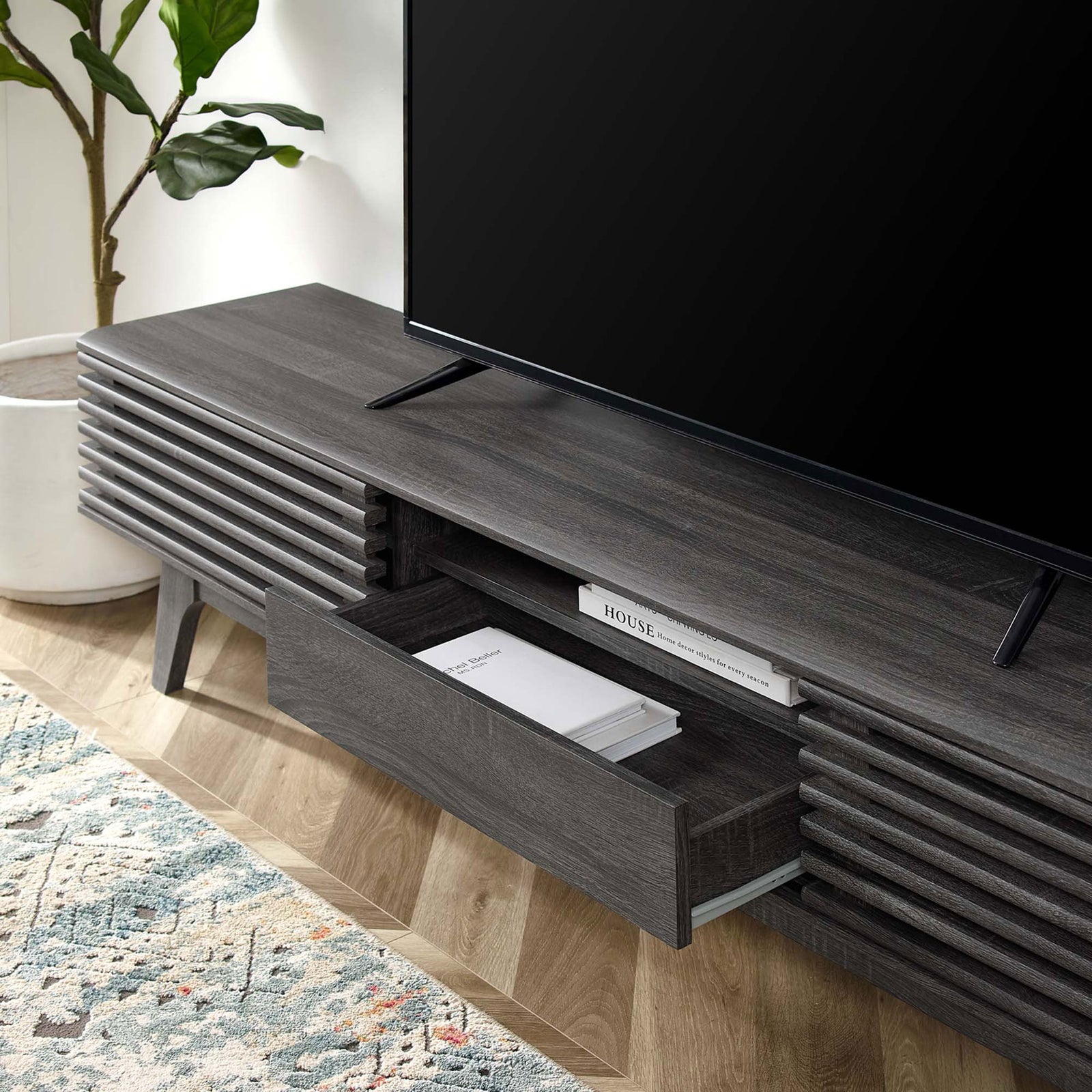 Charcoal TV stand in use with drawer open and books stored on the center shelf || EEI-3305-CHA || front_angle_open_room