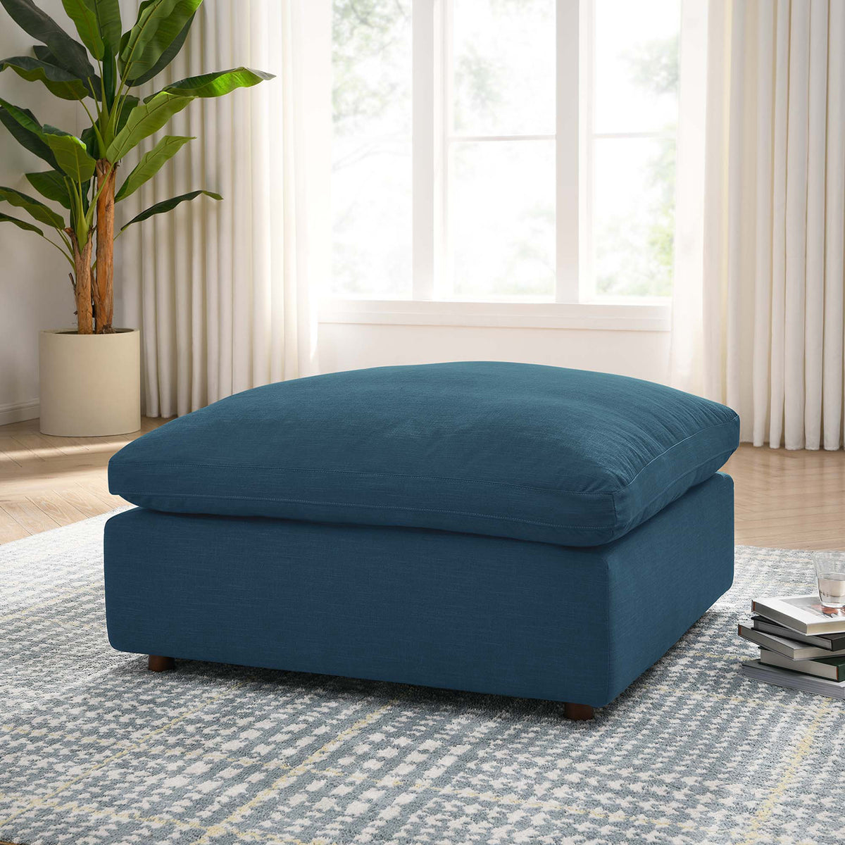 A generously cushioned azure ottoman brings an easygoing focal point to the living room