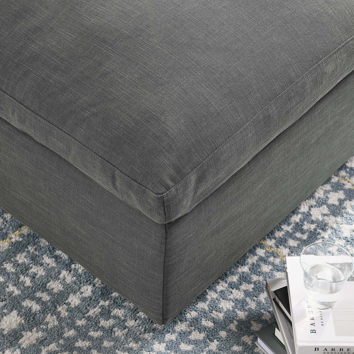 Fine gray fabric and crisp seams finish the edge of the oversized cushion