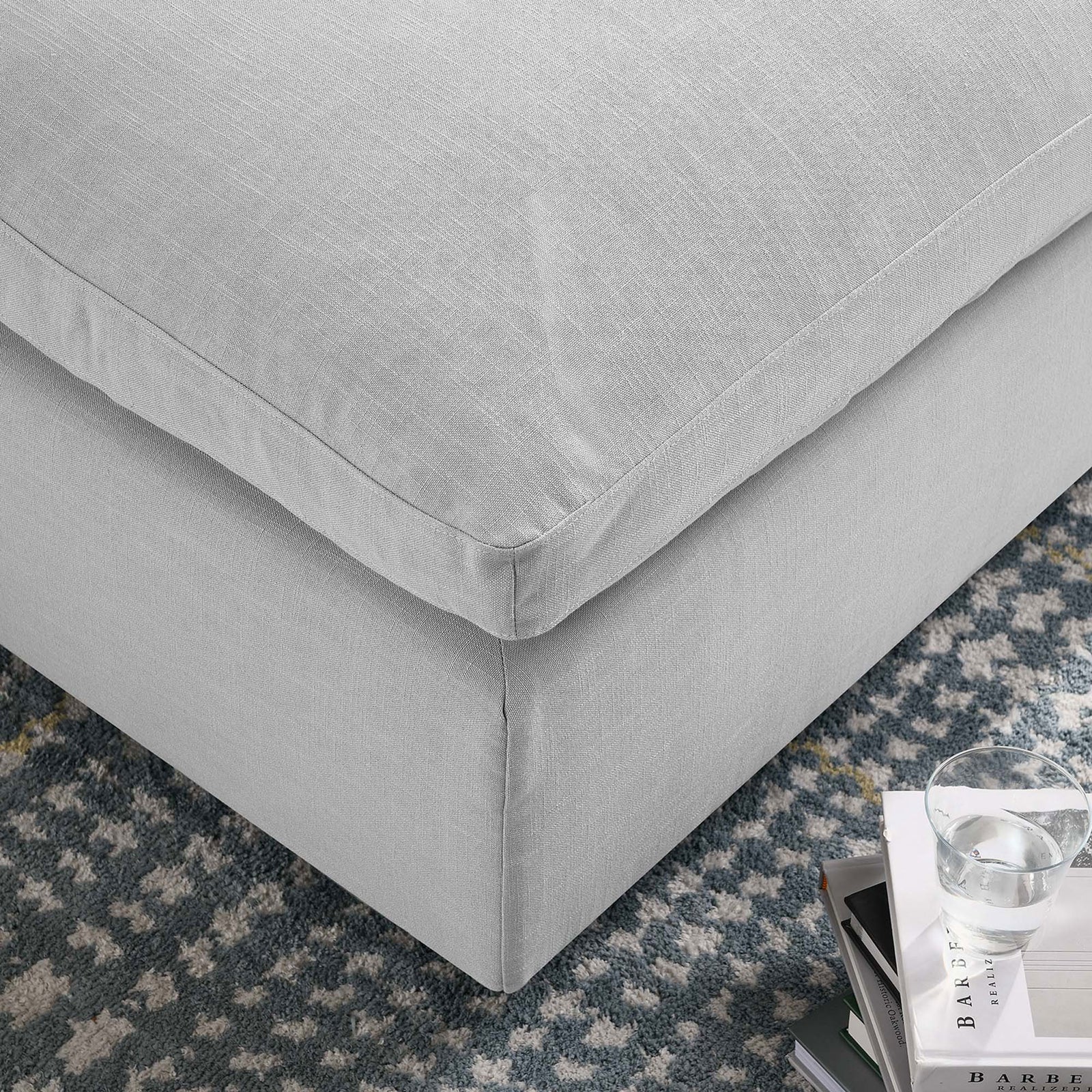 Soft linen-textured upholstery and plush cushion corner promise cozy comfort for everyday lounging. || EEI-3318-LGR || detail_room
