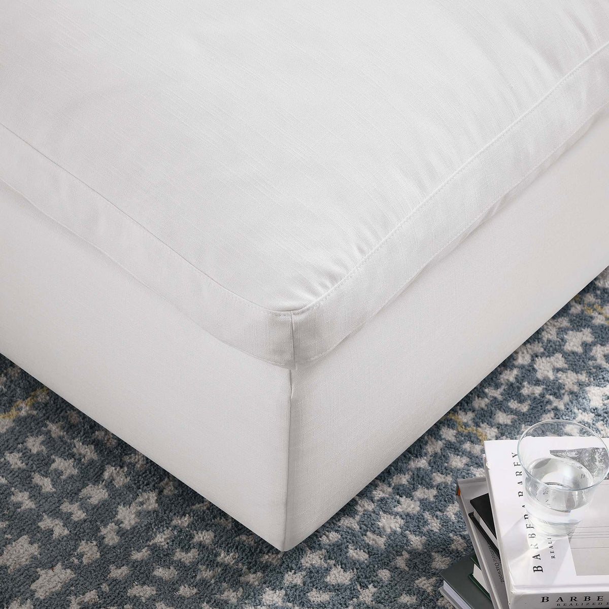 Commix ottoman corner highlighting the tailored piping, linen-textured pure white fabric, and cozy living room setting || EEI-3318-PUW || detail_room