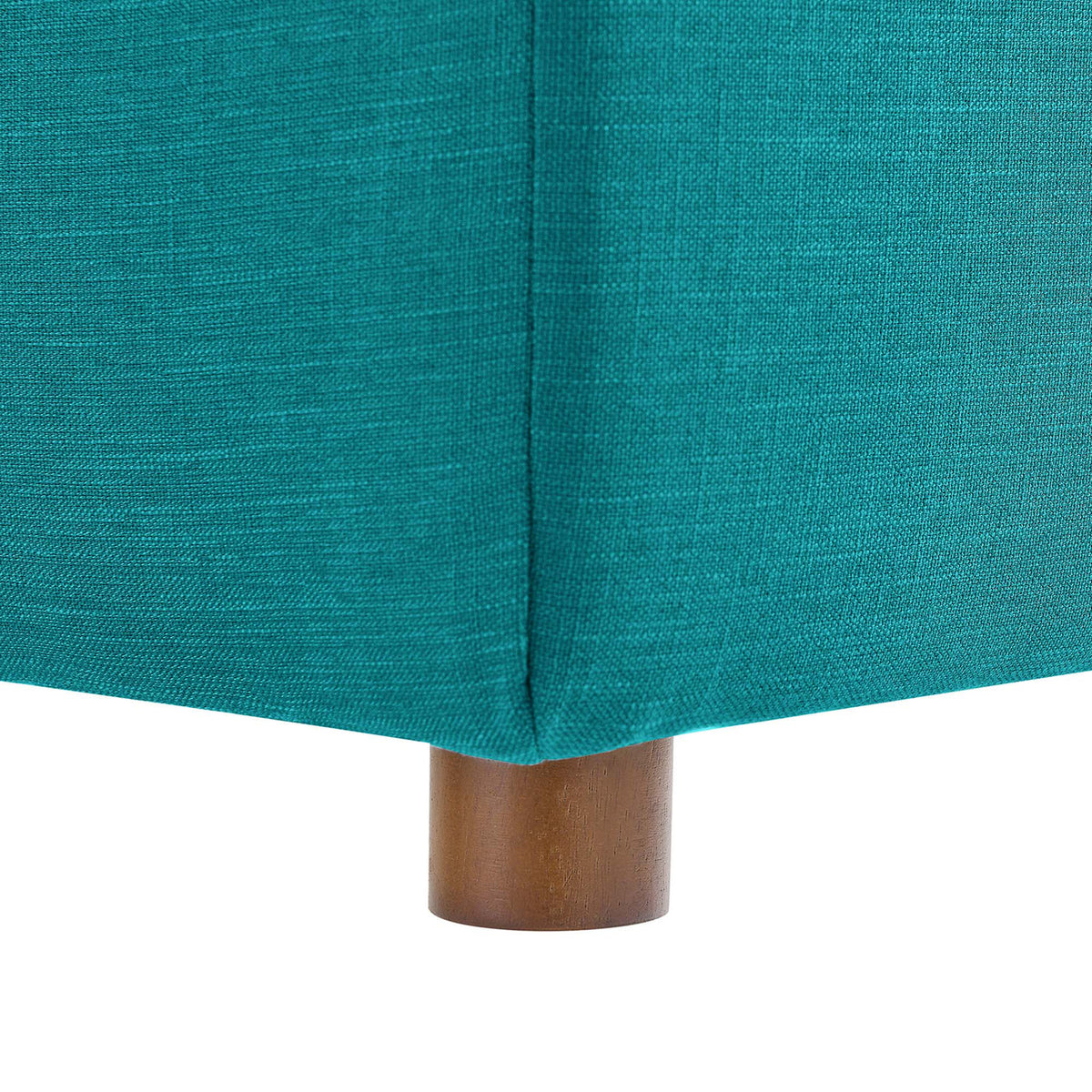 A honey-toned wood foot grounds the crisply tailored teal upholstered base