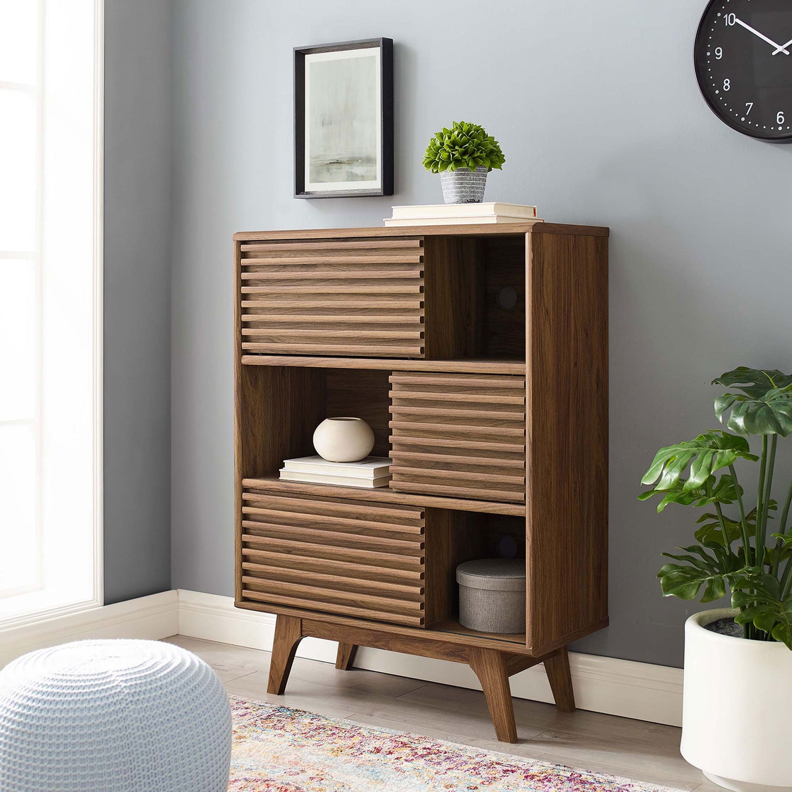 Render walnut display cabinet styled in a bright living room with decor arranged on open and closed shelves || EEI-3343-WAL || front_angle_open_room