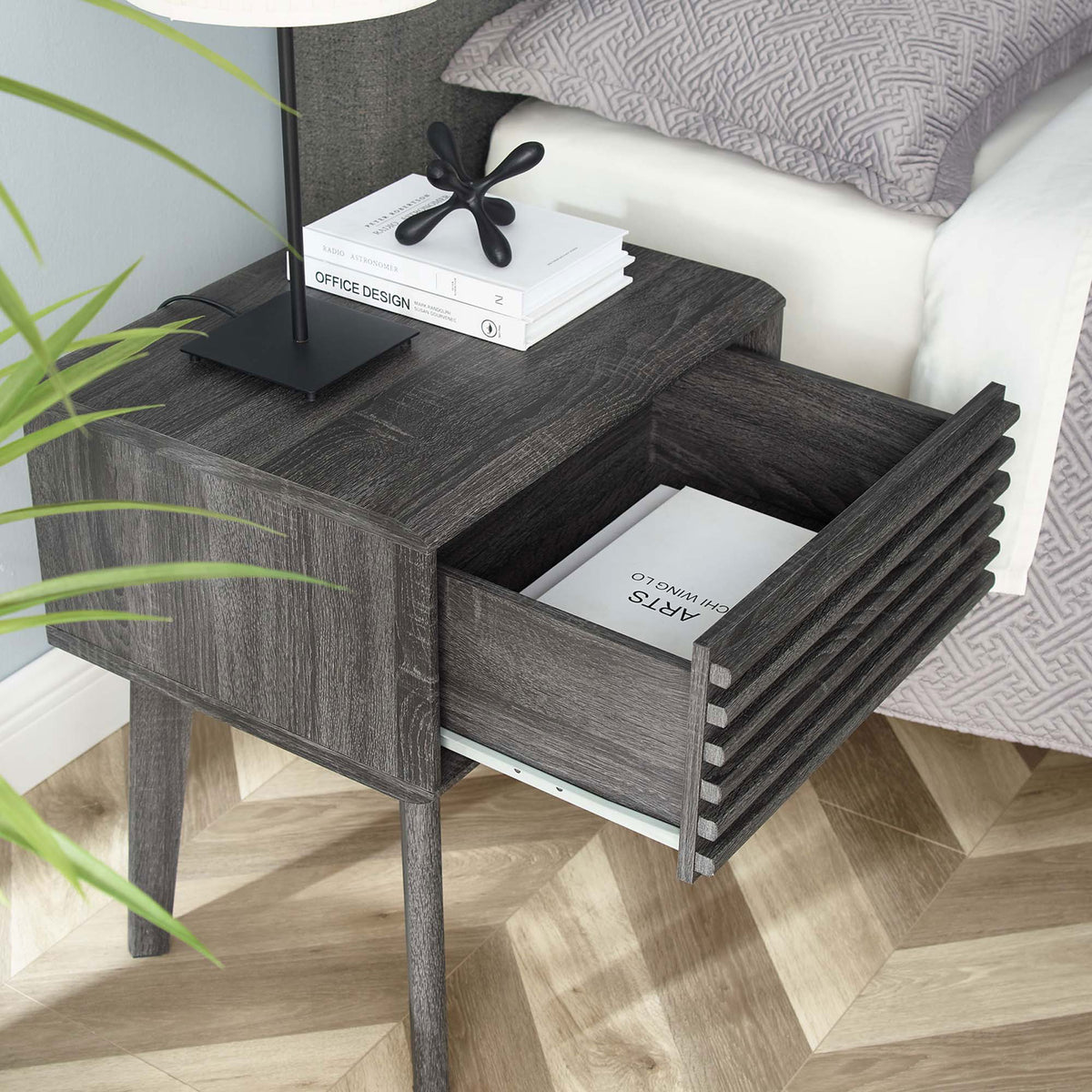 Charcoal nightstand beside bed with drawer open to reveal books and bedside essentials || EEI-3345-CHA || front_angle_open_room