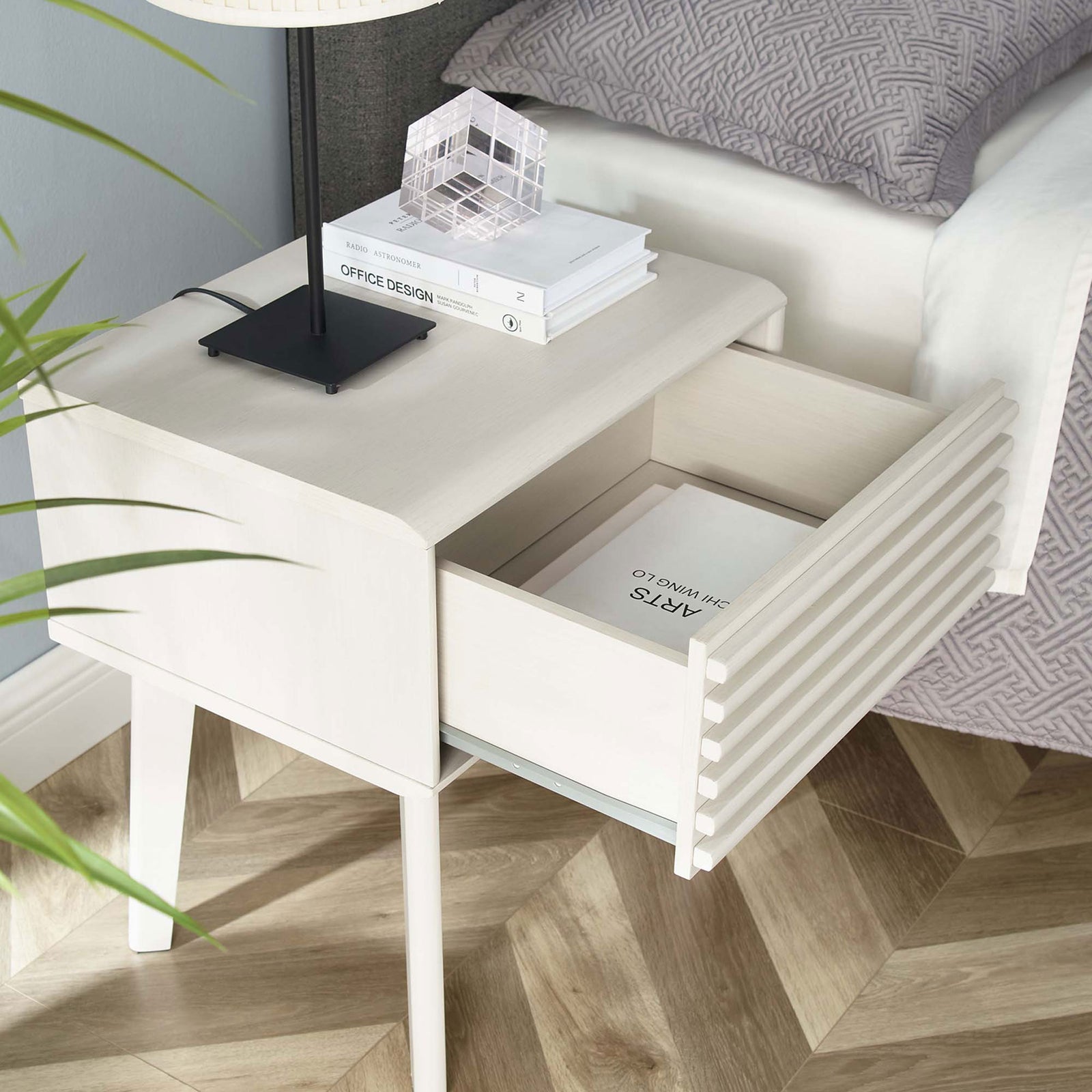 Nightstand drawer pulled open to keep nighttime essentials within easy reach beside a contemporary upholstered bed. || EEI-3345-WHI || front_angle_open_room