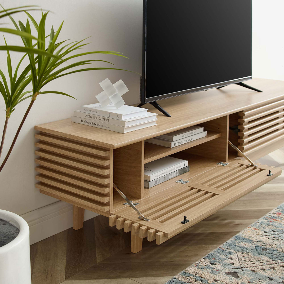 Oak TV stand in a living room with drop-down doors open to reveal media storage. || EEI-3348-OAK || front_angle_open_room