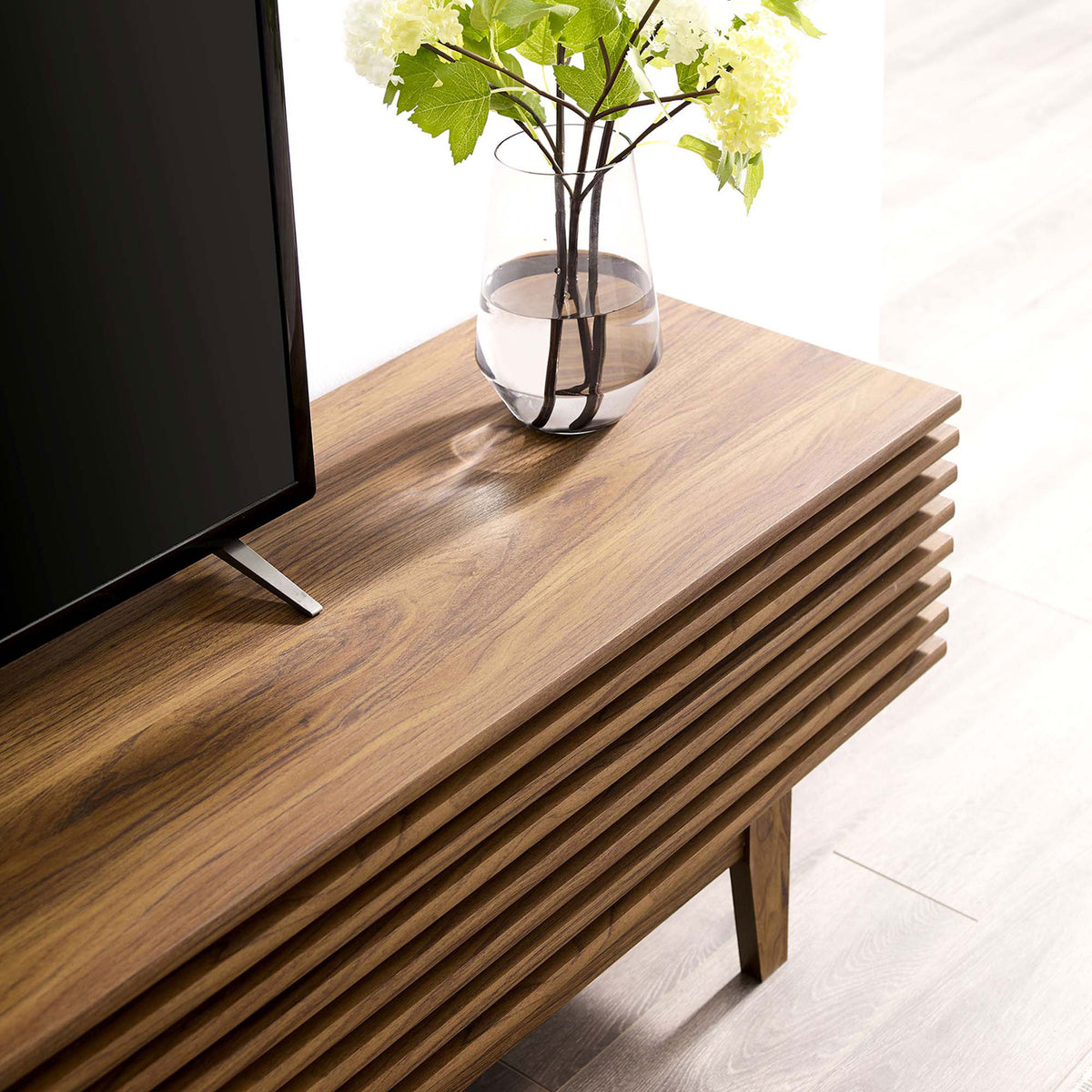 Walnut TV stand top styled with vase and decor to showcase rich wood grain. || EEI-3348-WAL || detail_room