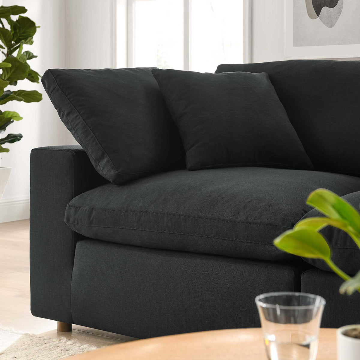 Overstuffed black seat and back cushions create a soft, sink-in lounging spot