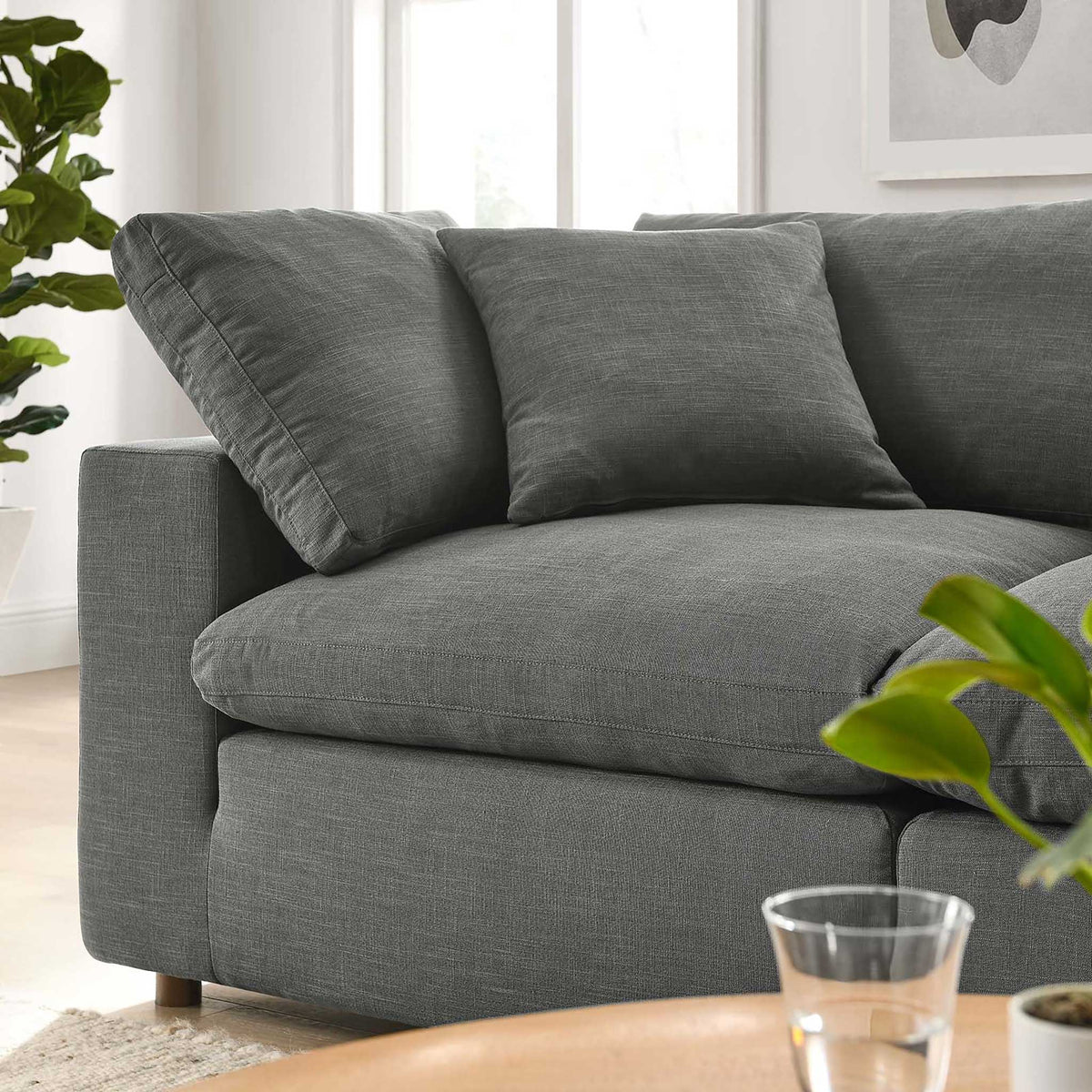 The gray sofa's substantial seat cushion and soft pillows promise sink-in comfort