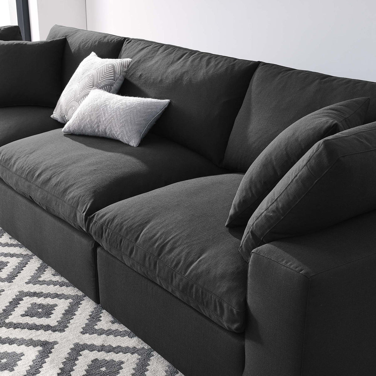 Deep black seat cushions and padded backs invite you to settle in