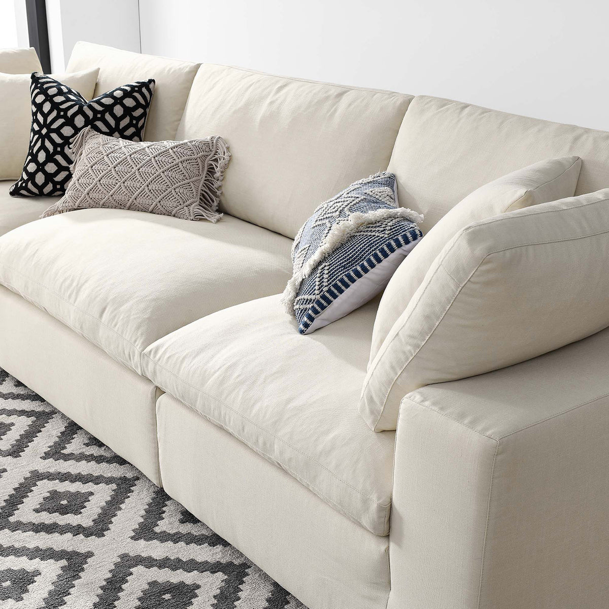 Roomy light beige cushions invite relaxed lounging with soft padded backs