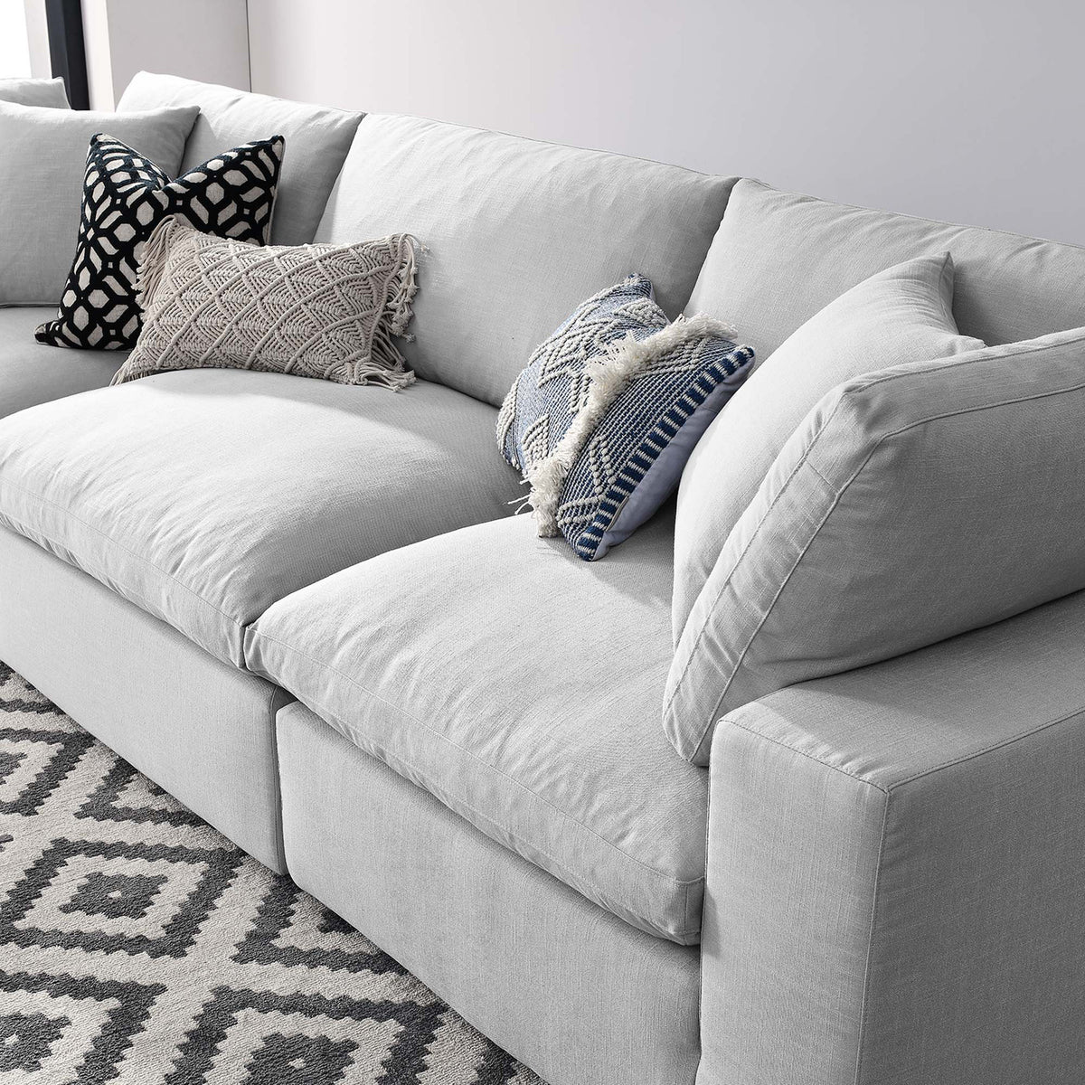 Overstuffed light gray seats and backs invite casual comfort