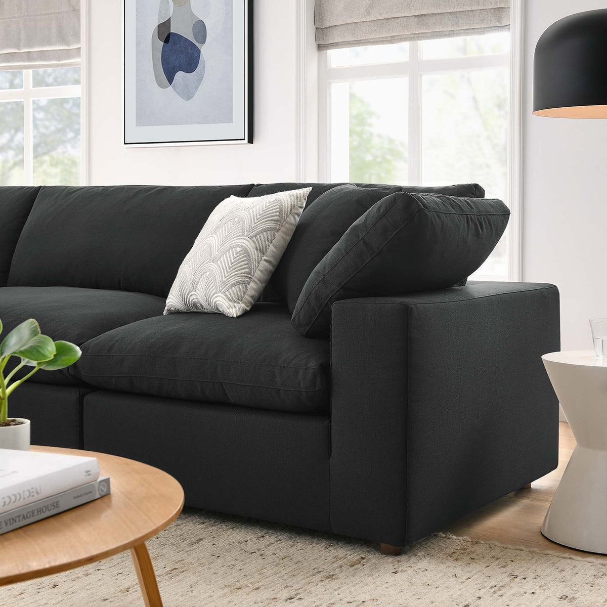 Layered back pillows and a deep black seat create a welcoming end to the sectional.
