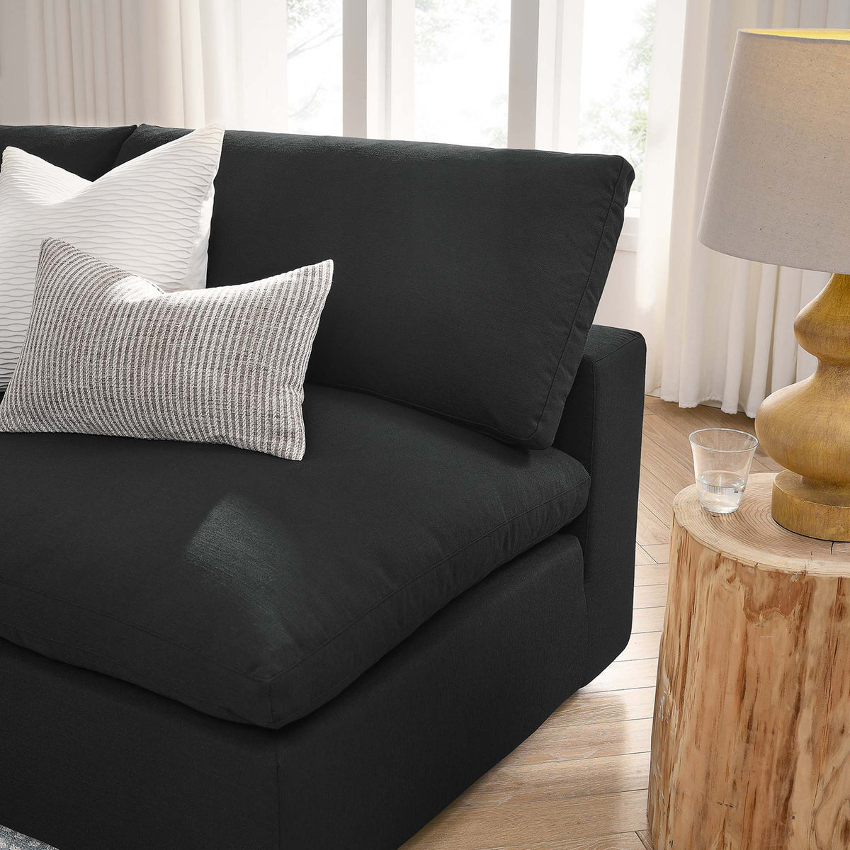 A deep black seat and lofty back cushion offer a welcoming place to curl up.