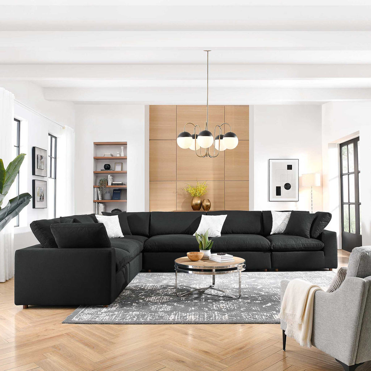 Deep black cushions stretch around the corner to create a relaxed gathering space.