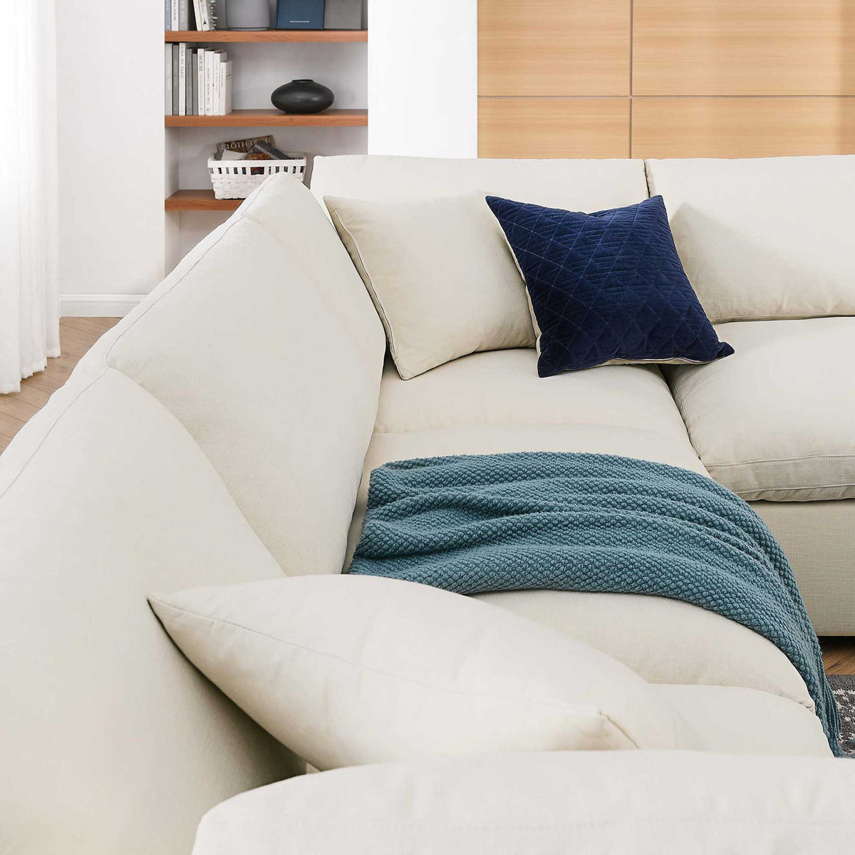 Light beige back and seat cushions make the sectional's corner especially inviting.