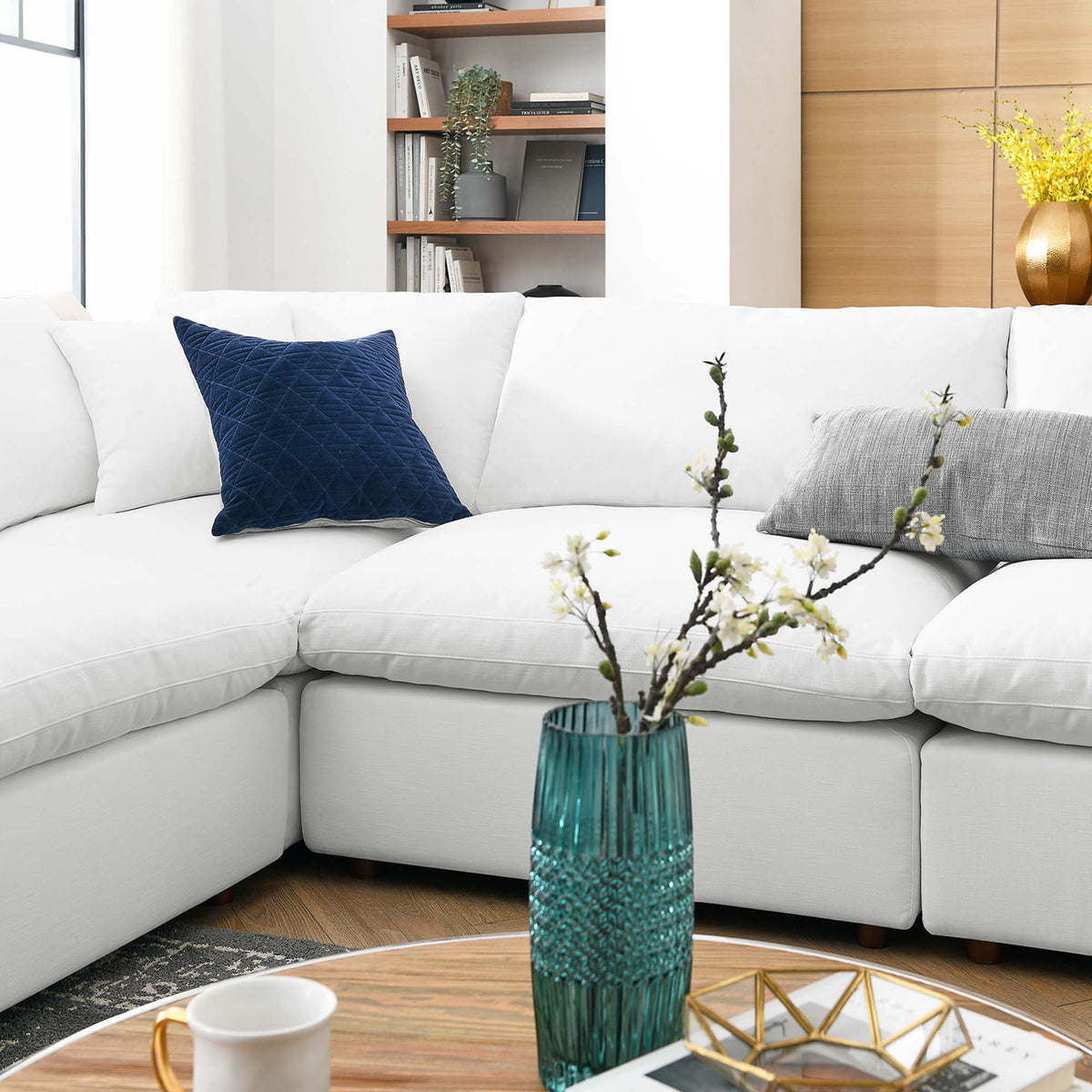 Plump white back pillows and generous seats create a soft, welcoming sectional.