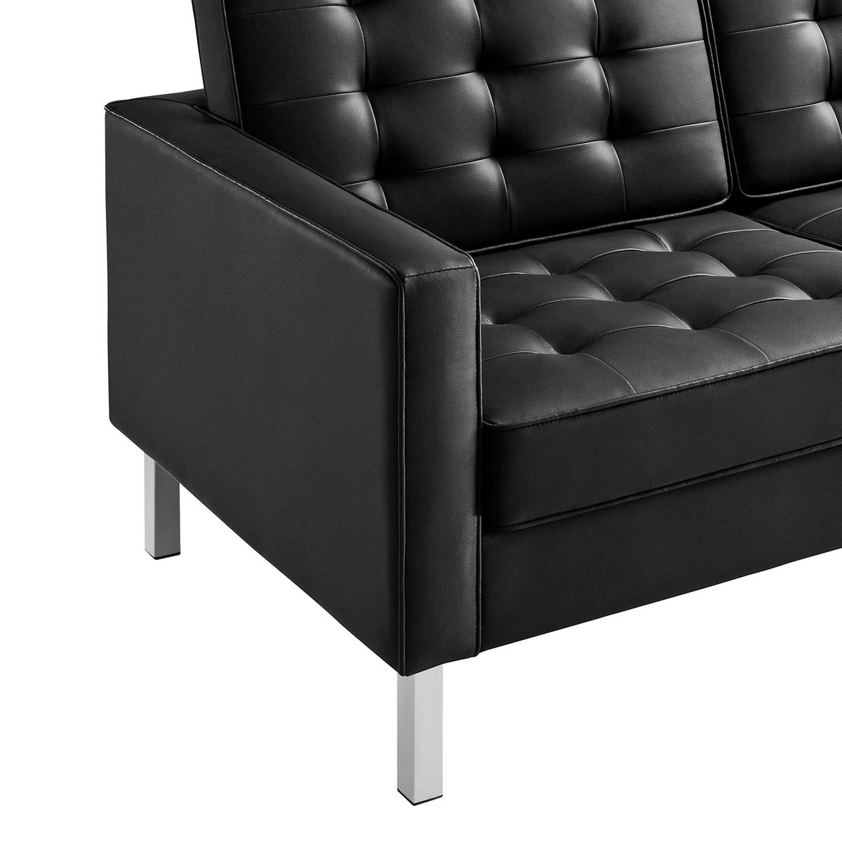 Biscuit-tufted black cushions pair with a tailored arm and sleek metal legs.