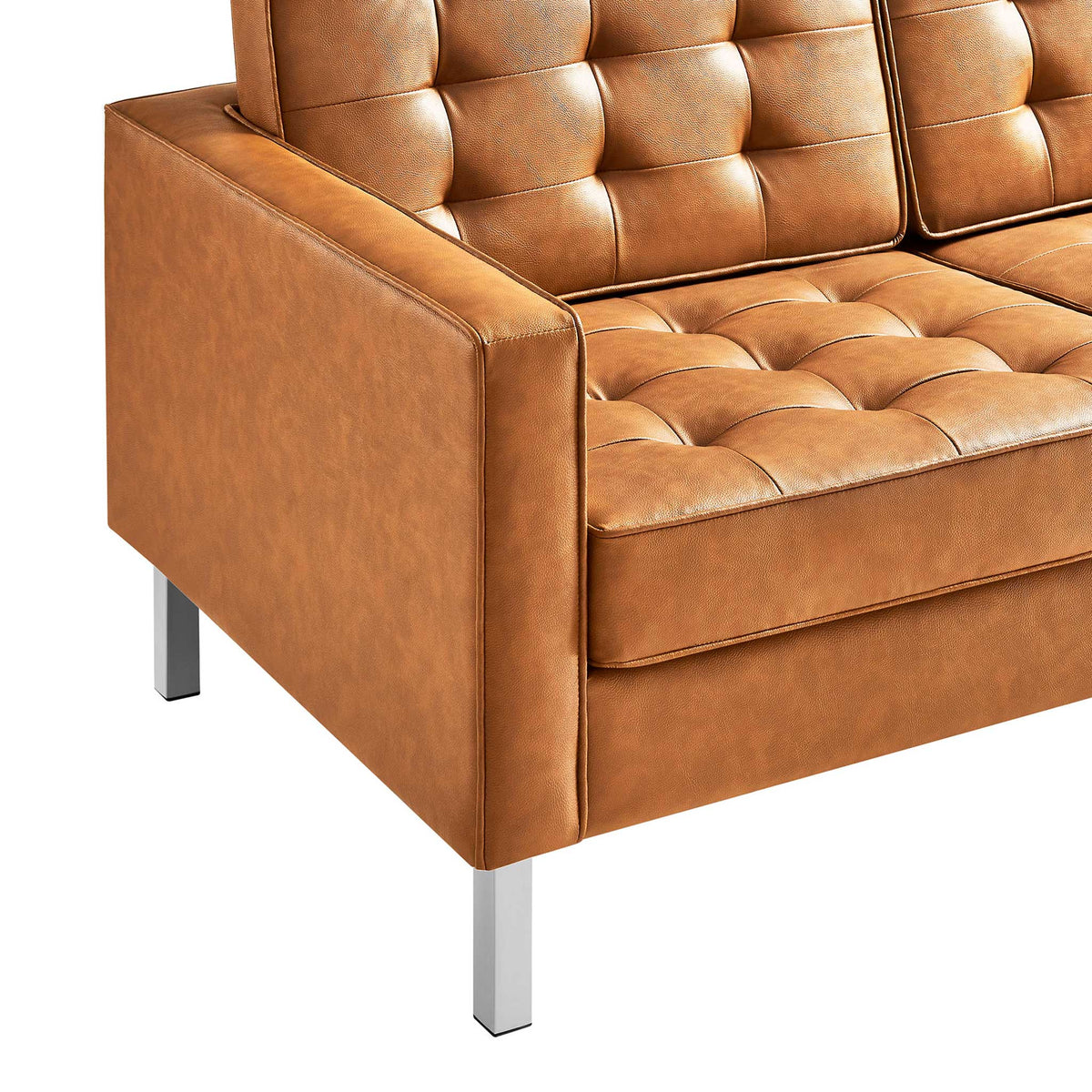 Tan biscuit-tufted cushions complement the upholstered arm and sleek metal legs.