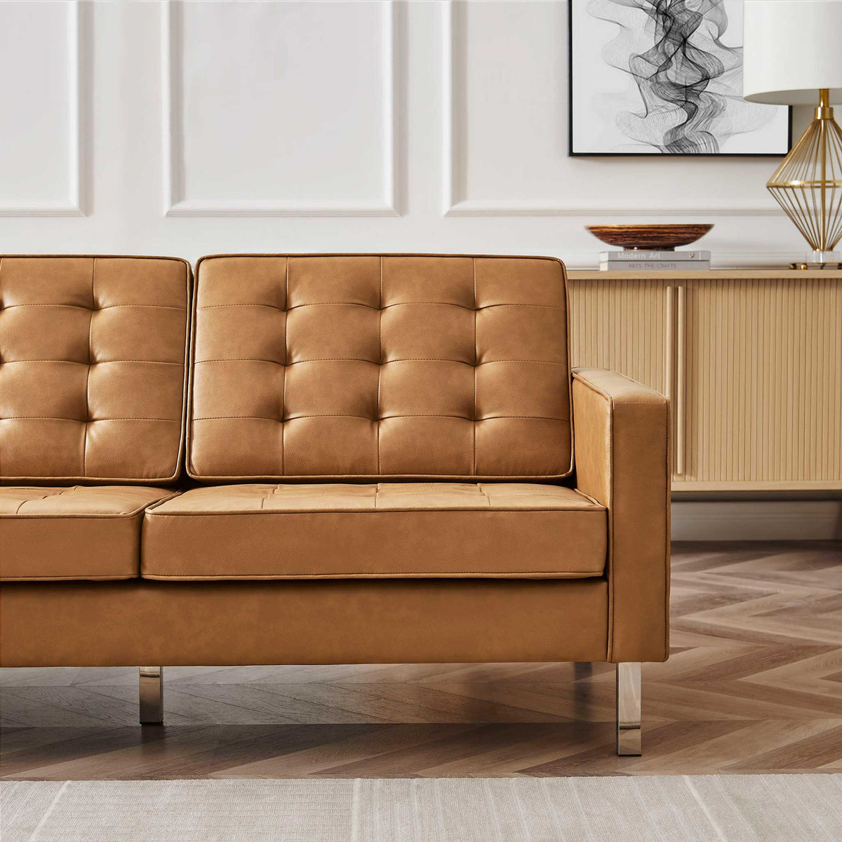 Warm tan tufted cushions and a structured arm add inviting texture to the sofa.