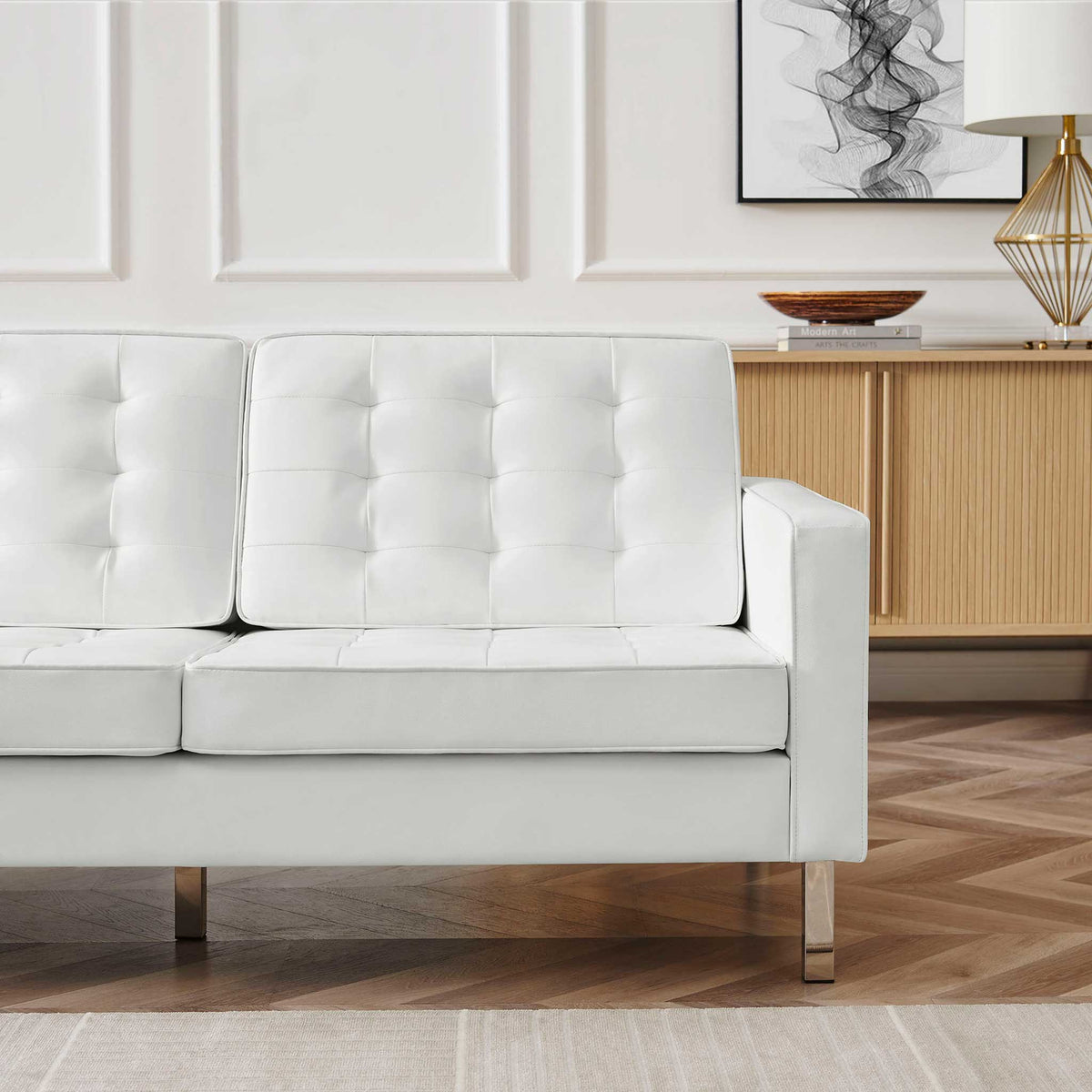 White biscuit-tufted cushions and a squared arm lend soft texture to a modern sofa.
