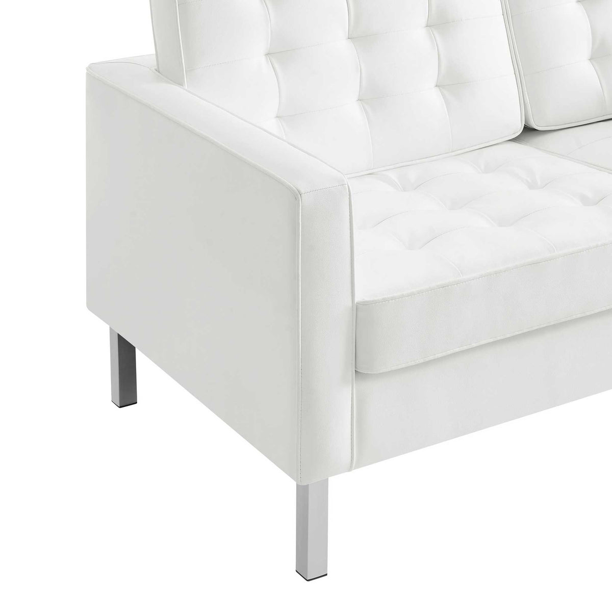 Soft white vegan leather, deep biscuit tufting, and precise seams give the cushions a polished finish.