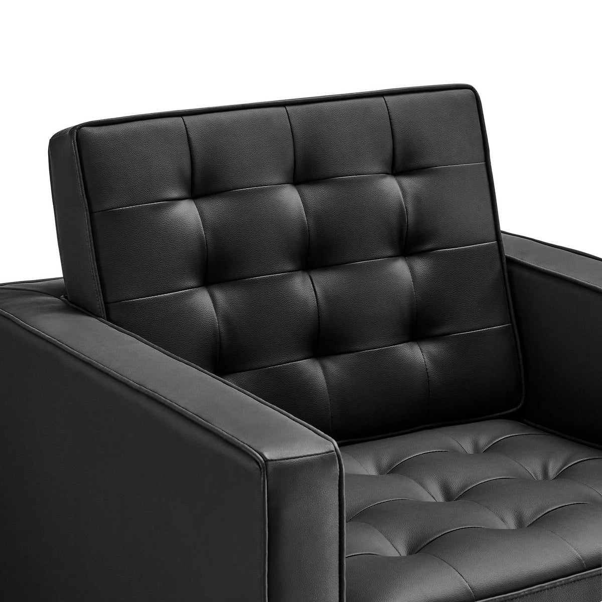 Plush biscuit tufting adds inviting texture to the black vegan leather back and seat.