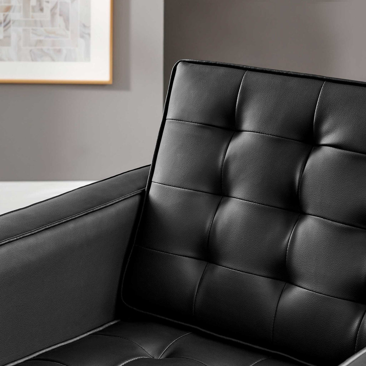 Softly dimpled black vegan leather gives the cushioned back and seat a rich texture.