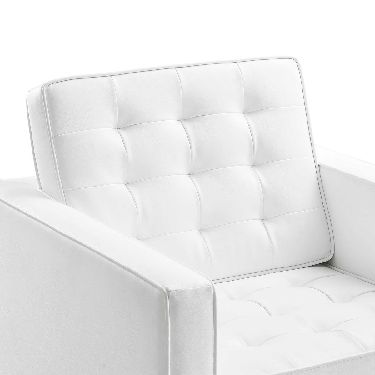 Plump biscuit tufting adds soft texture to this white vegan leather armchair's seat and back.