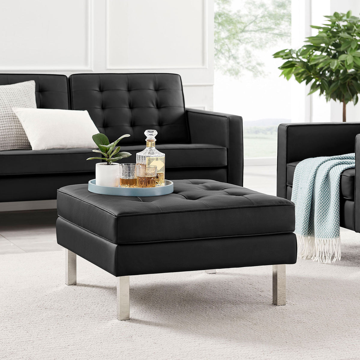 Black tufted ottoman paired with matching sofa and armchair in bright living room || EEI-3394-SLV-BLK || front_angle_room