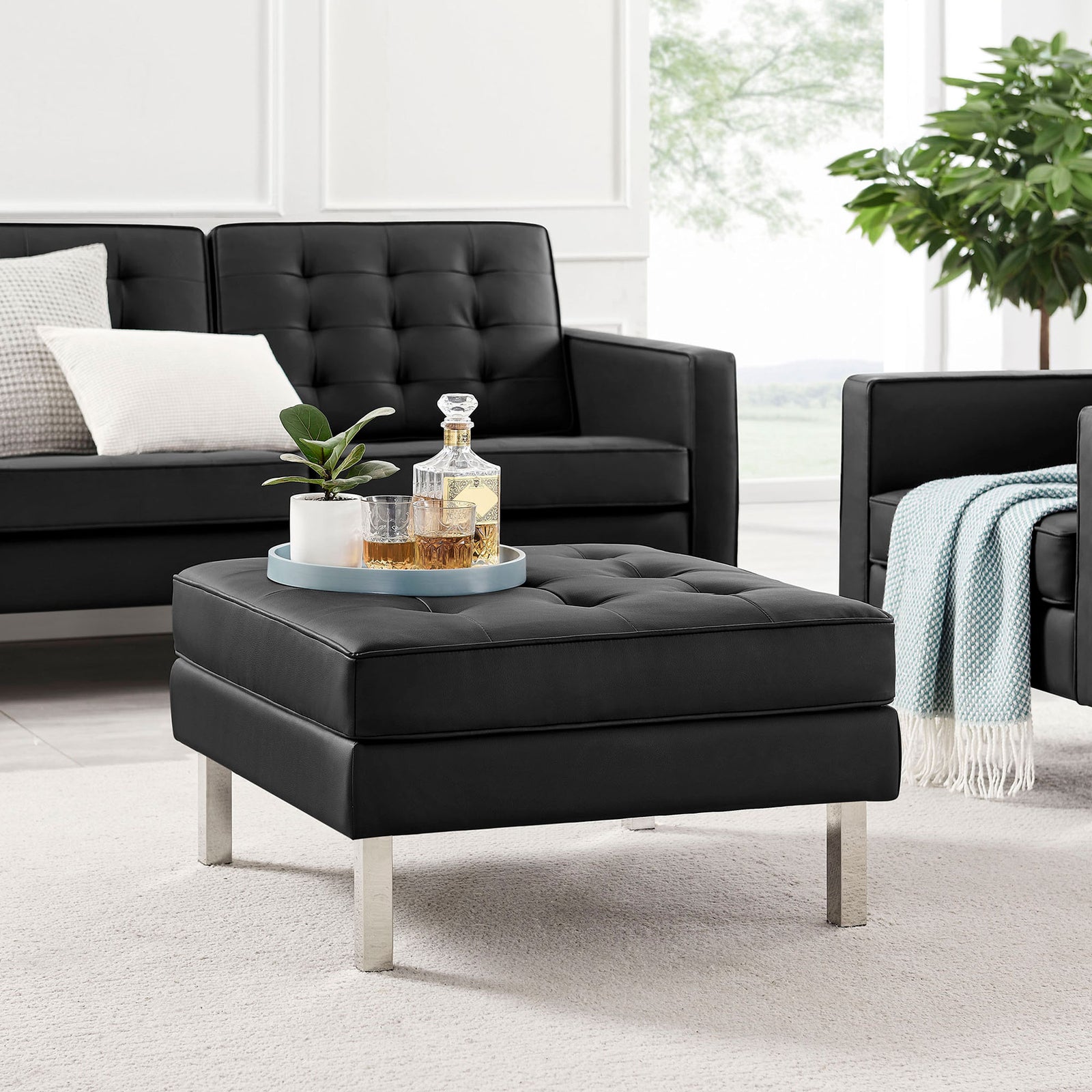 Black tufted ottoman paired with matching sofa and armchair in bright living room || EEI-3394-SLV-BLK || front_angle_room