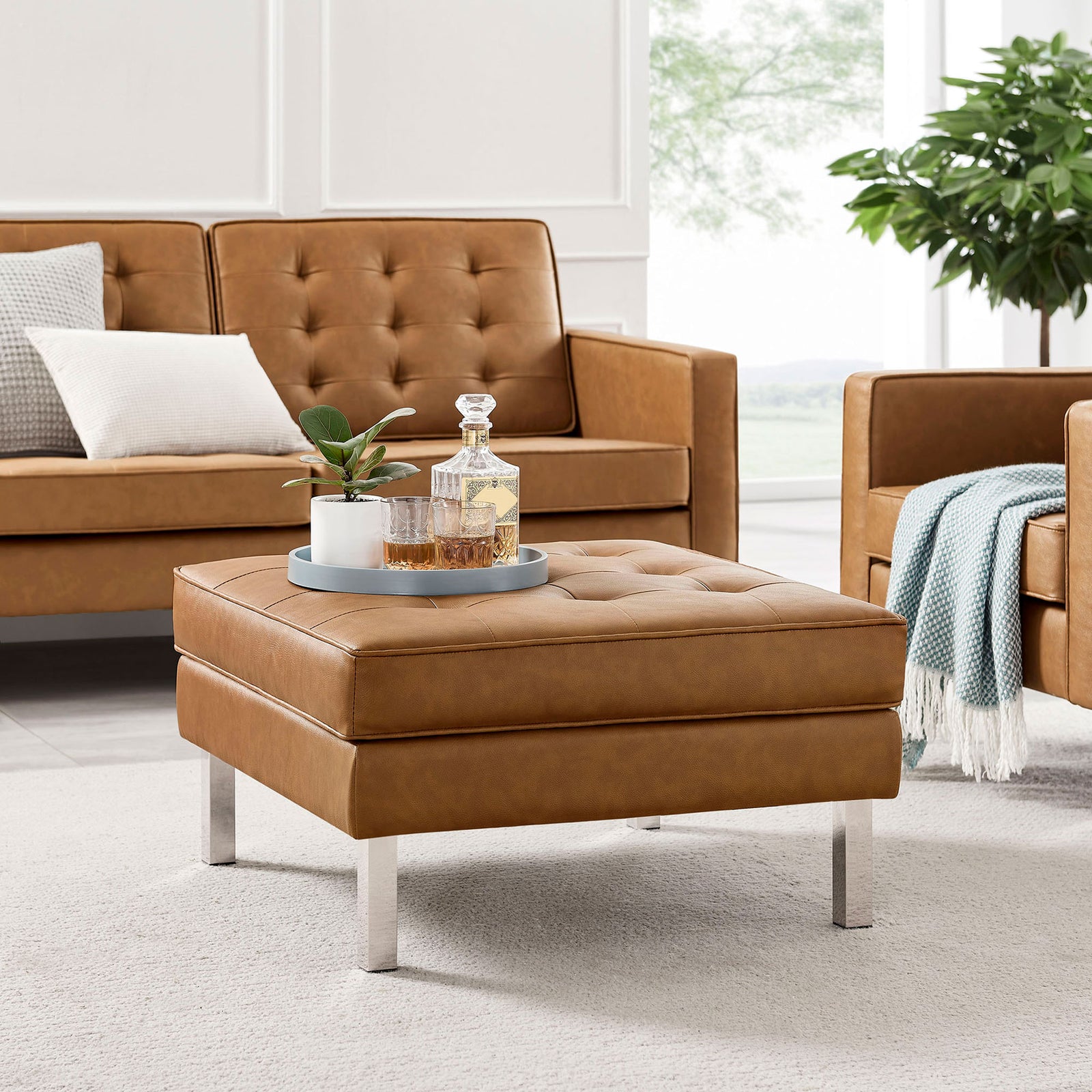 Loft vegan leather ottoman in tan paired with matching seating in a bright living room || EEI-3394-SLV-TAN || front_angle_room