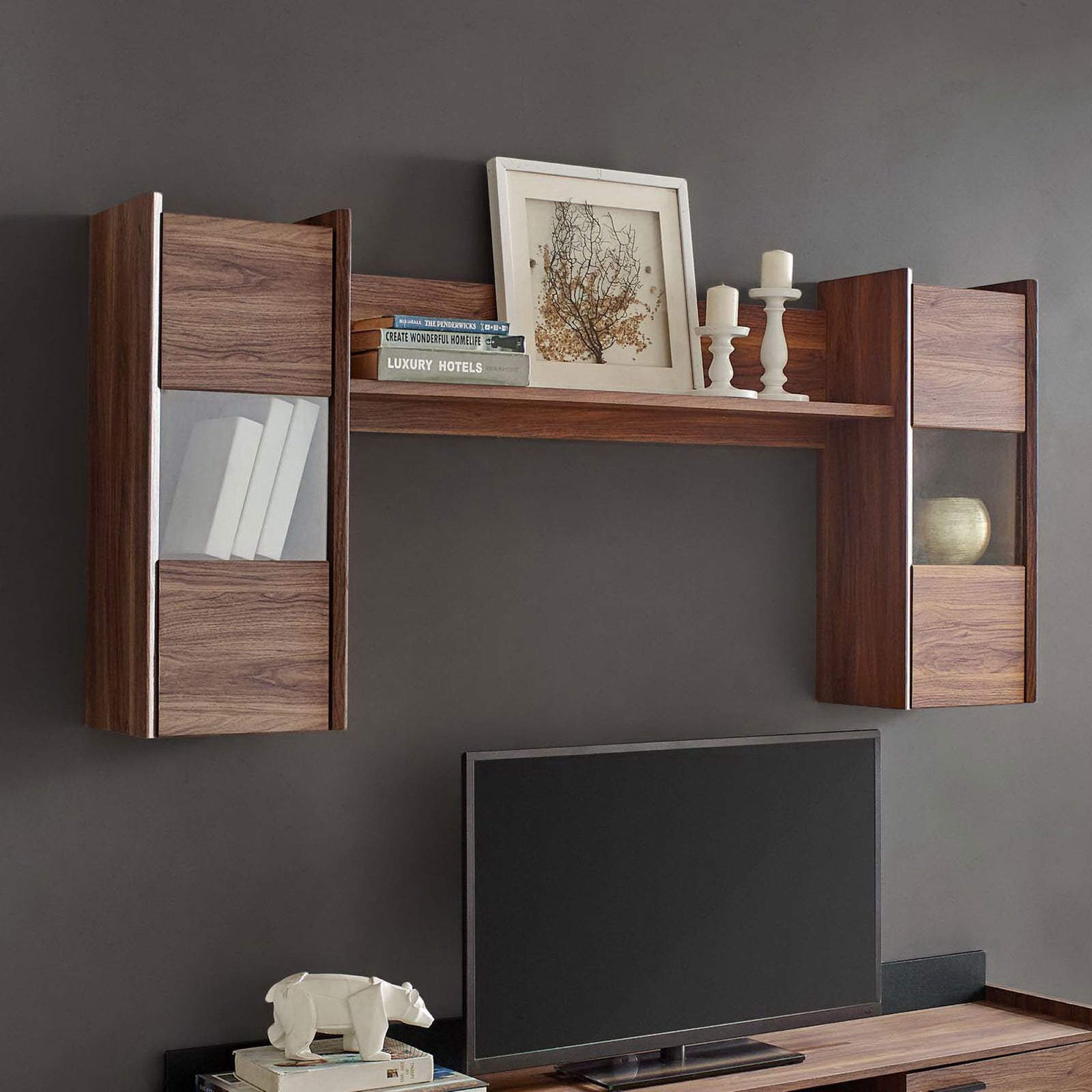 Walnut wall-mounted shelf styled above a media console with books, candles, and decor accents displayed || EEI-3436-WAL || front_room