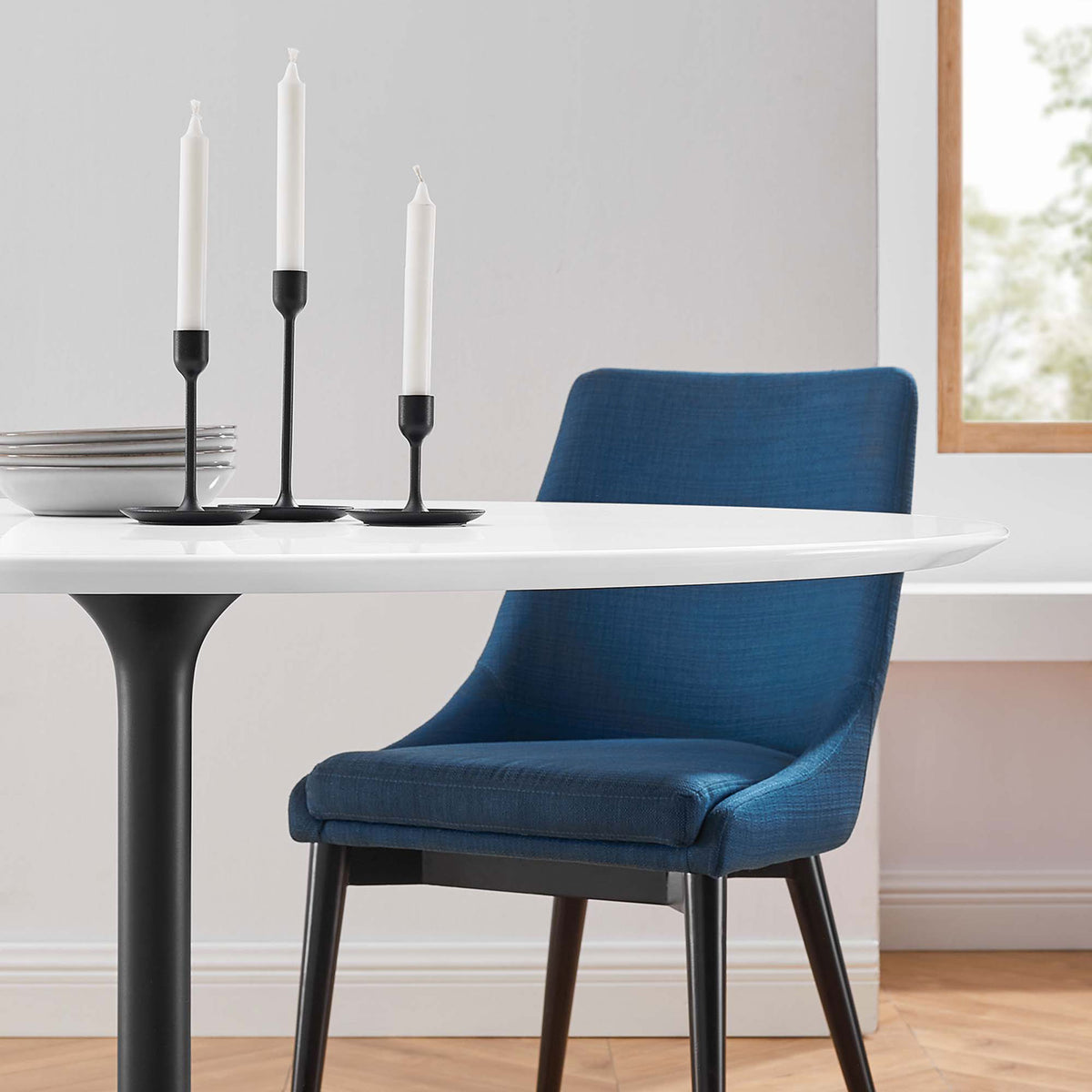 Close-up of white tabletop dressed with candles and plates for an elevated dinner setting || EEI-3523-BLK-WHI || detail_room