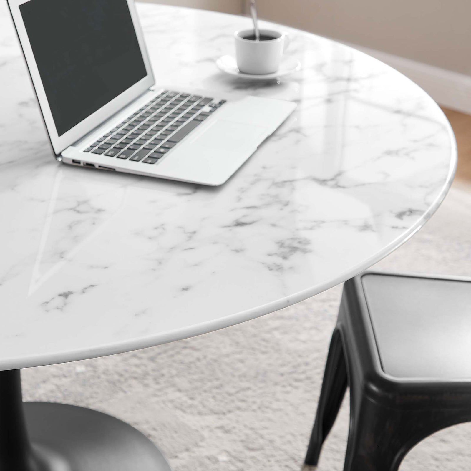 Detail of 54 inch faux marble tabletop styled as a workspace with laptop and coffee cup || EEI-3528-BLK-WHI || detail_room