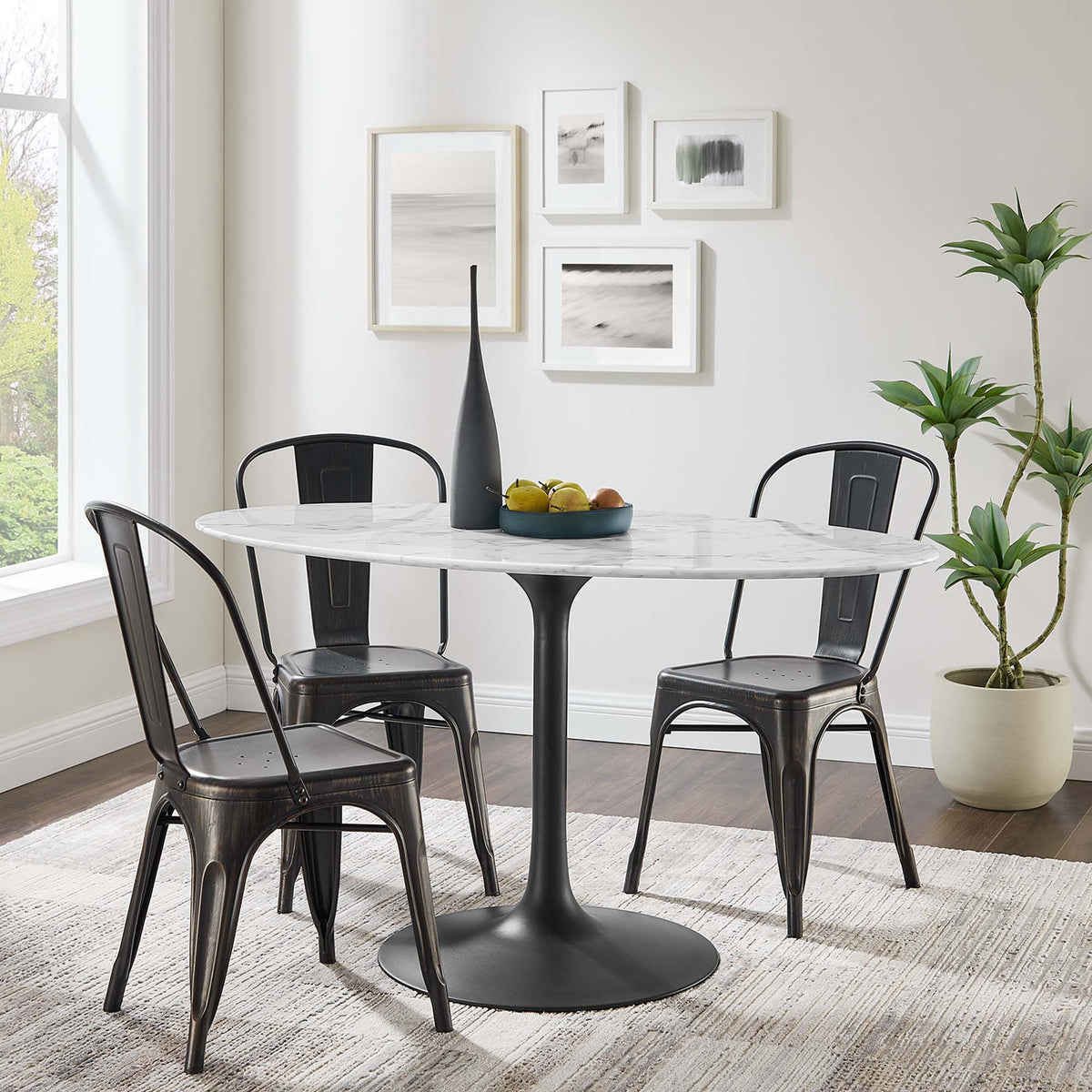 Lippa 54 inch oval faux marble dining table with black pedestal base anchors a bright contemporary dining space || EEI-3530-BLK-WHI || front_angle_room