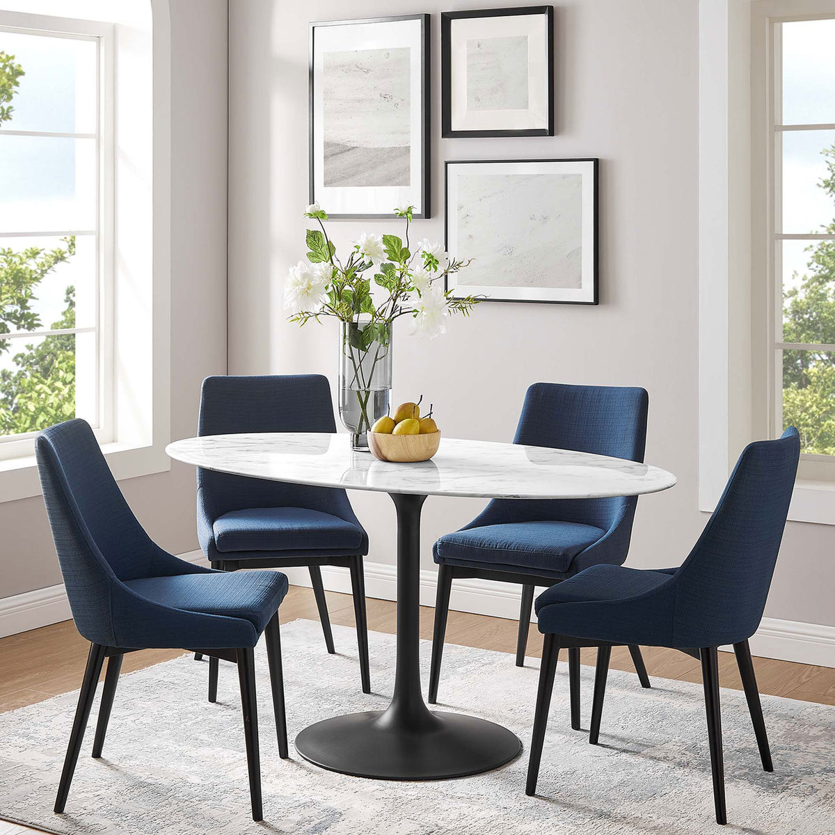 Lippa 60 inch oval faux marble dining table with black pedestal base centered in a stylish modern dining room || EEI-3531-BLK-WHI || front_angle_room