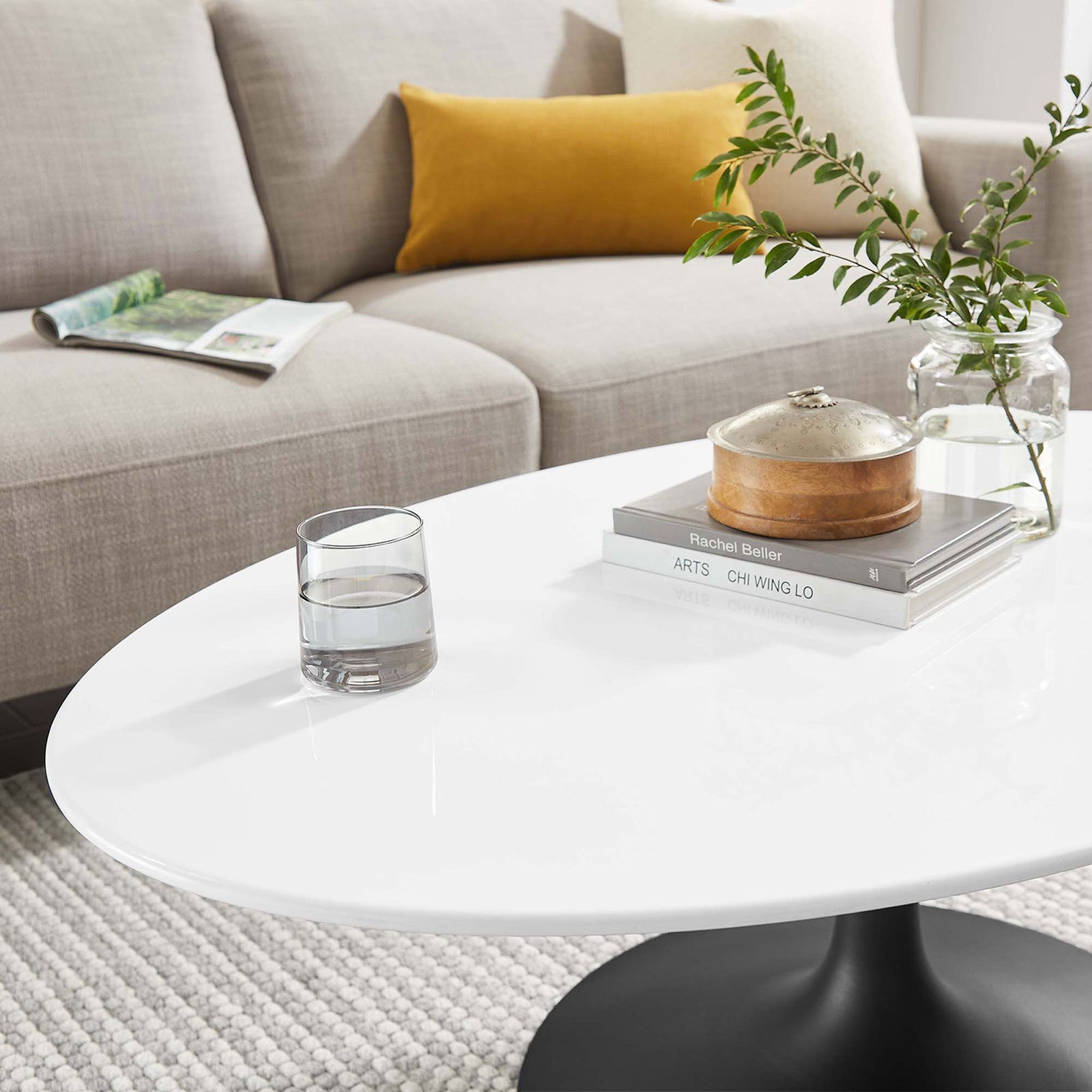 Glossy white surface styled with books and glassware on a cozy rug. || EEI-3533-BLK-WHI || detail_room
