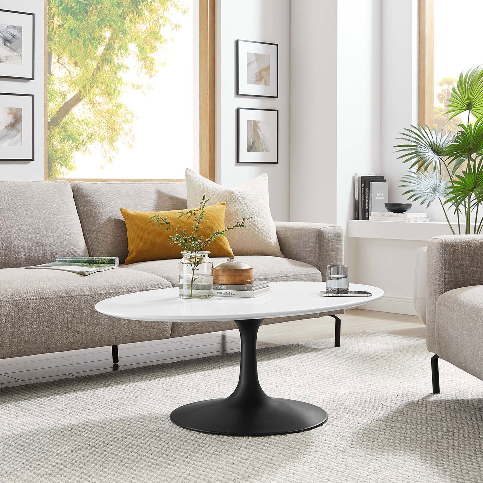 Mid-century pedestal coffee table anchors a bright, inviting living room. || EEI-3533-BLK-WHI || front_angle_room
