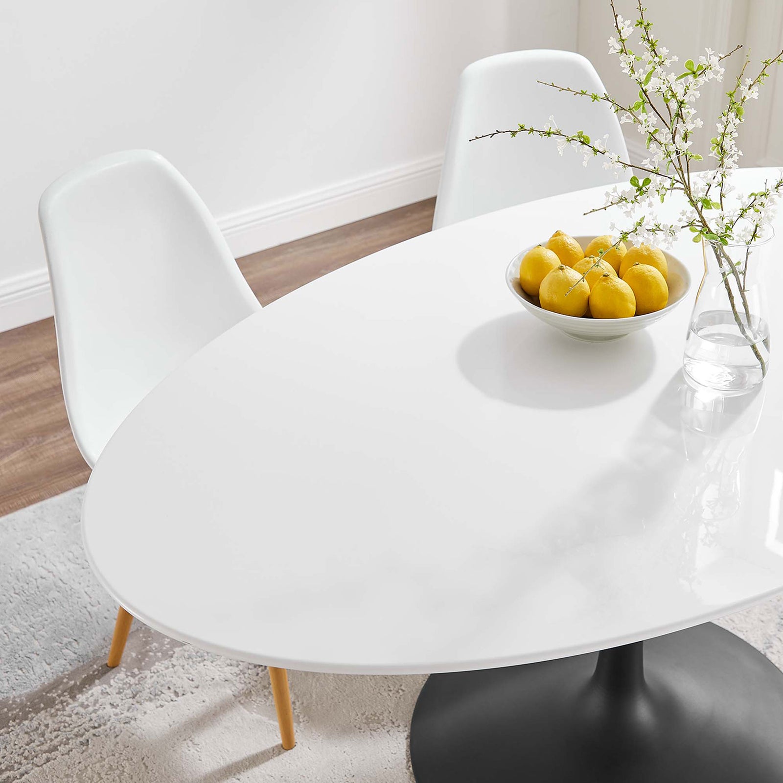 Lustrous white tabletop styled with lemons and minimalist decor for a fresh contemporary dining feel || EEI-3539-BLK-WHI || detail_room