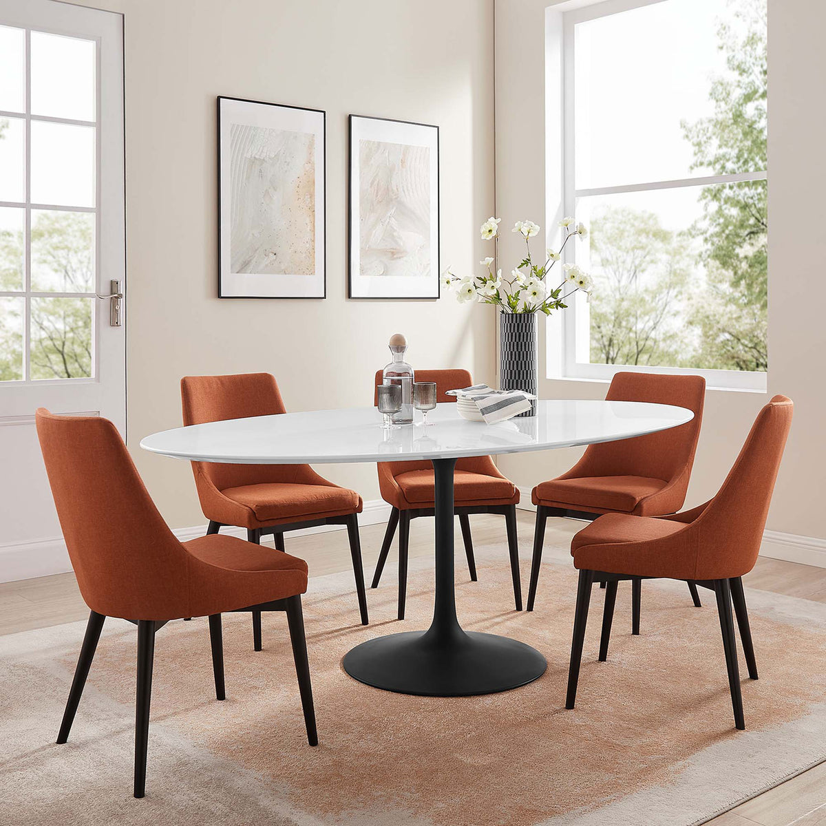 White oval pedestal dining table with black base styled with six rust orange chairs in a cozy dining room || EEI-3540-BLK-WHI || front_angle_room