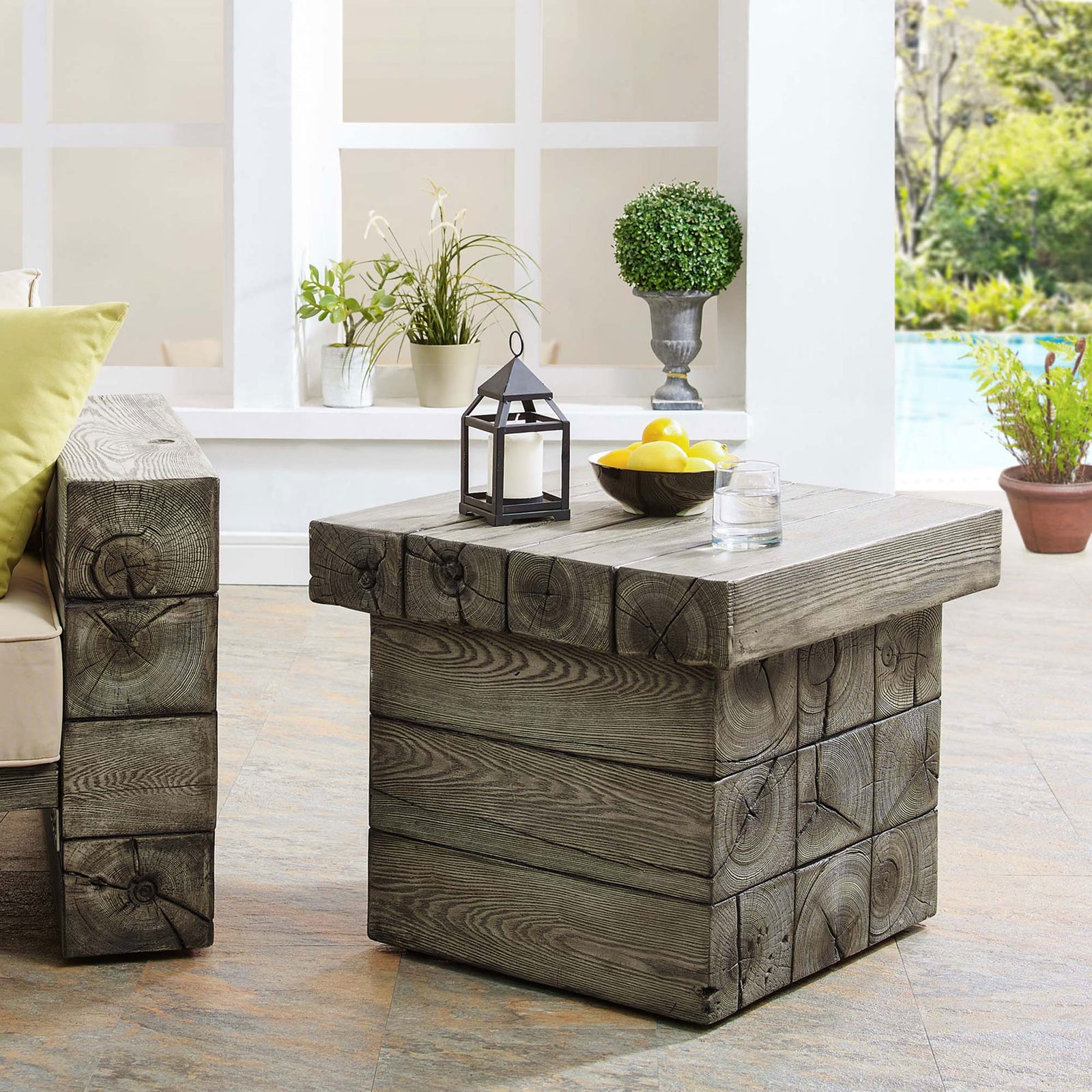 Rustic coastal side table anchors a relaxed outdoor lounge beside the pool. || EEI-3562-LGR || front_angle_room