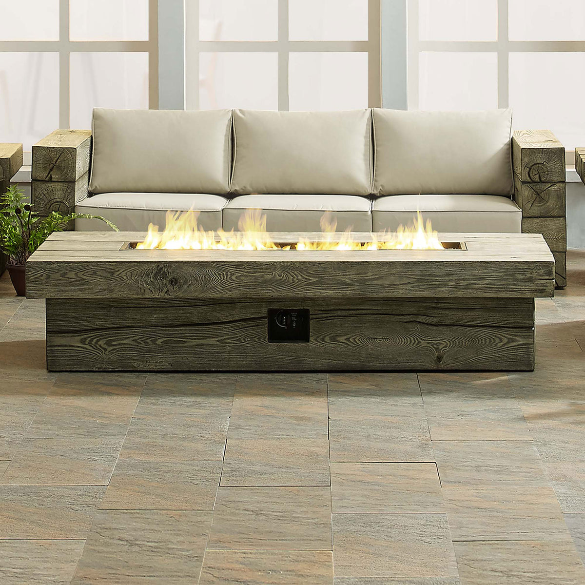 Modern patio seating area centered around the Manteo fire table with a full line of golden flames || EEI-3563-LGR || front_on_room